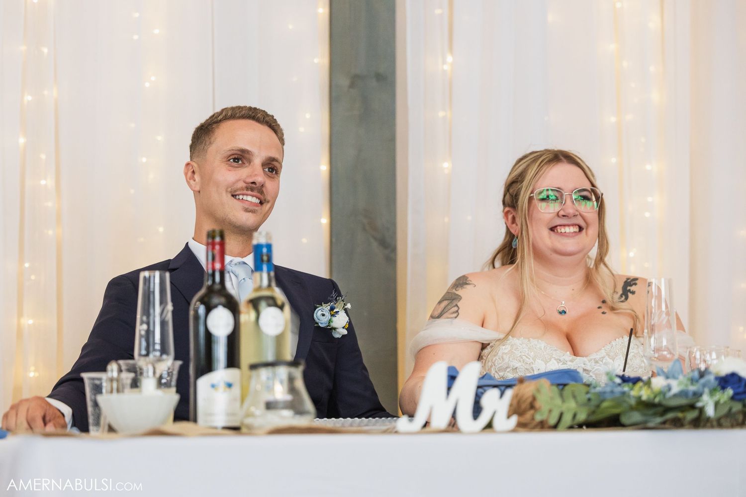 Wedding party guests enjoying a joyful reception celebration at an elegant indoor venue.