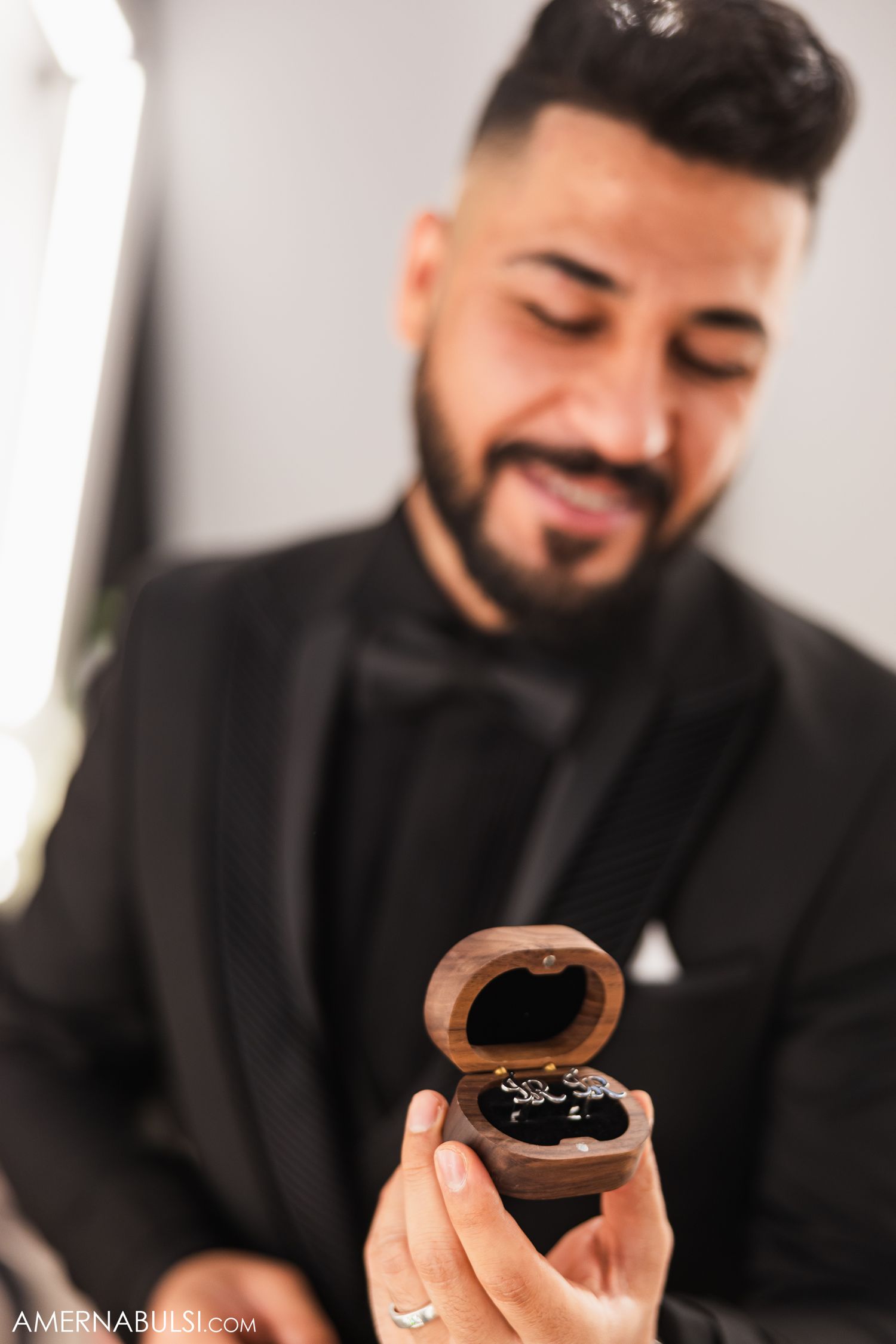 Close-up shots of someone in formal attire examining a ring box.