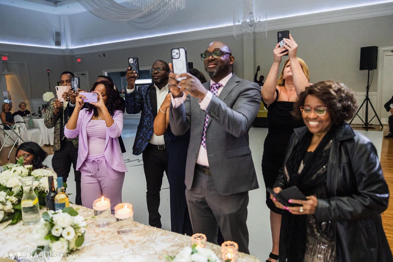 A romantic first dance between newlyweds in an elegantly decorated reception hall.