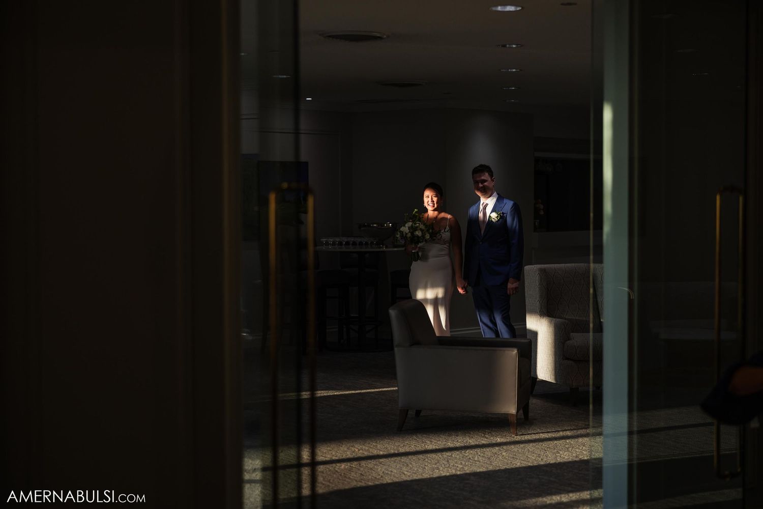 A business person working late at night in a dimly lit office with a laptop.