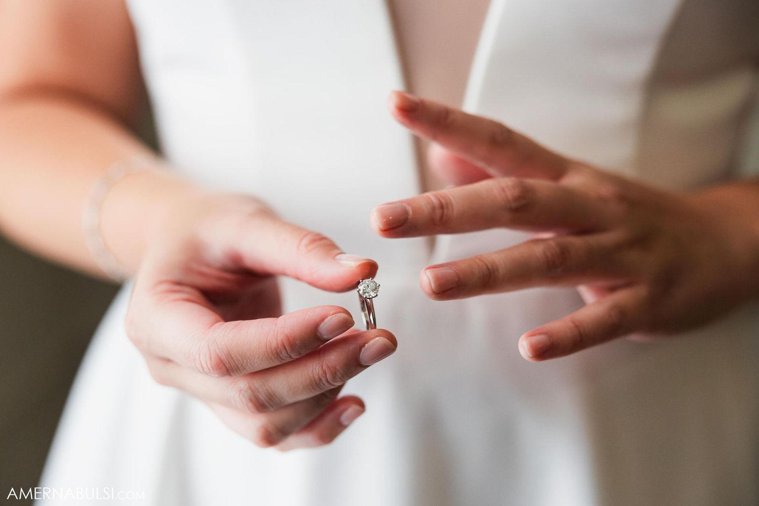 Close-up shot of hands exchanging a wedding ring during a ceremony.