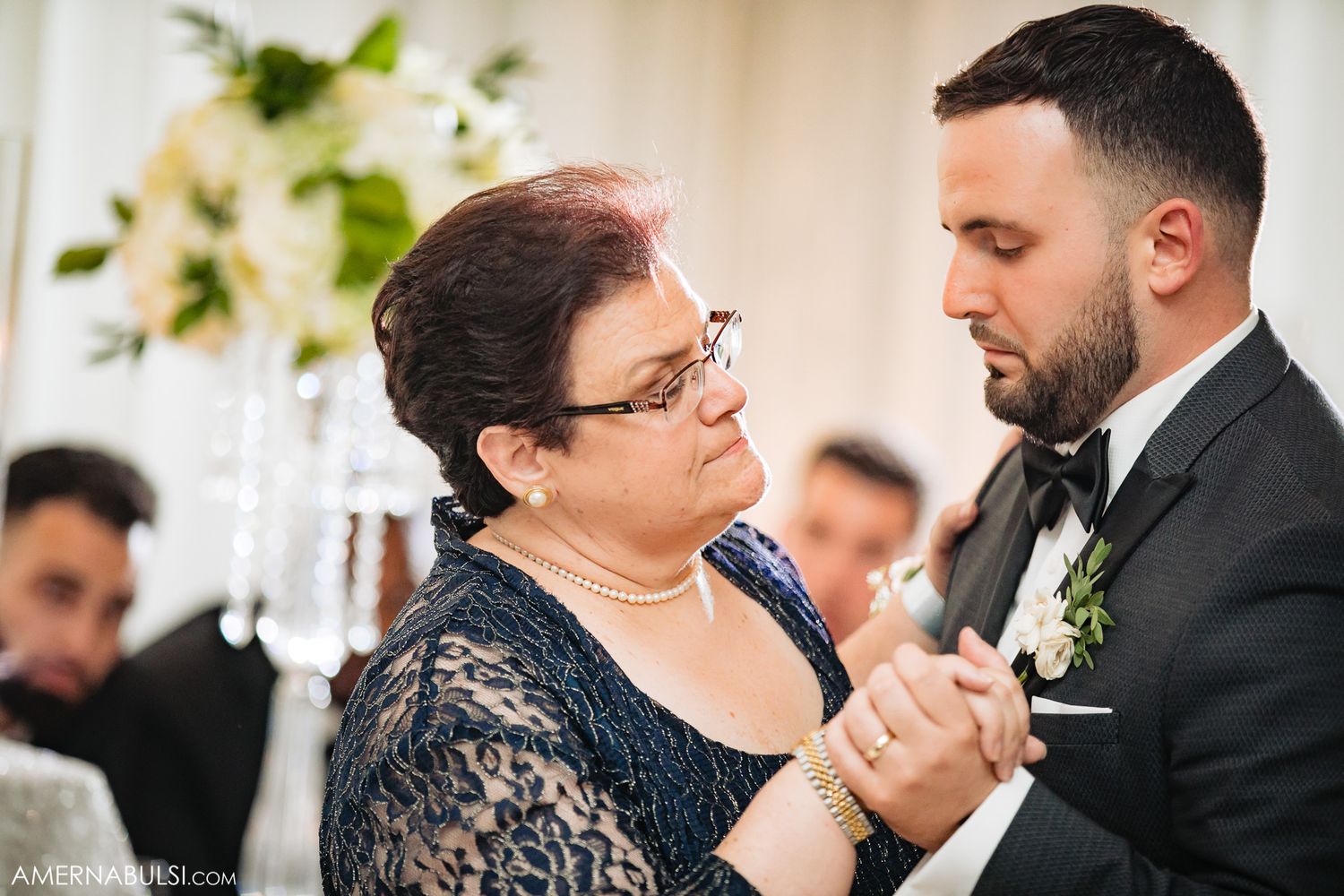 Wedding reception dance moment captured in elegant indoor setting.