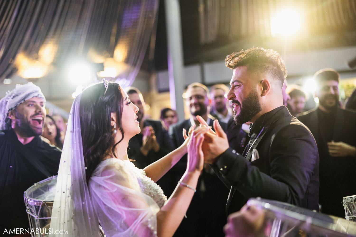 Energetic dance party scene with guests celebrating under dramatic venue lighting.