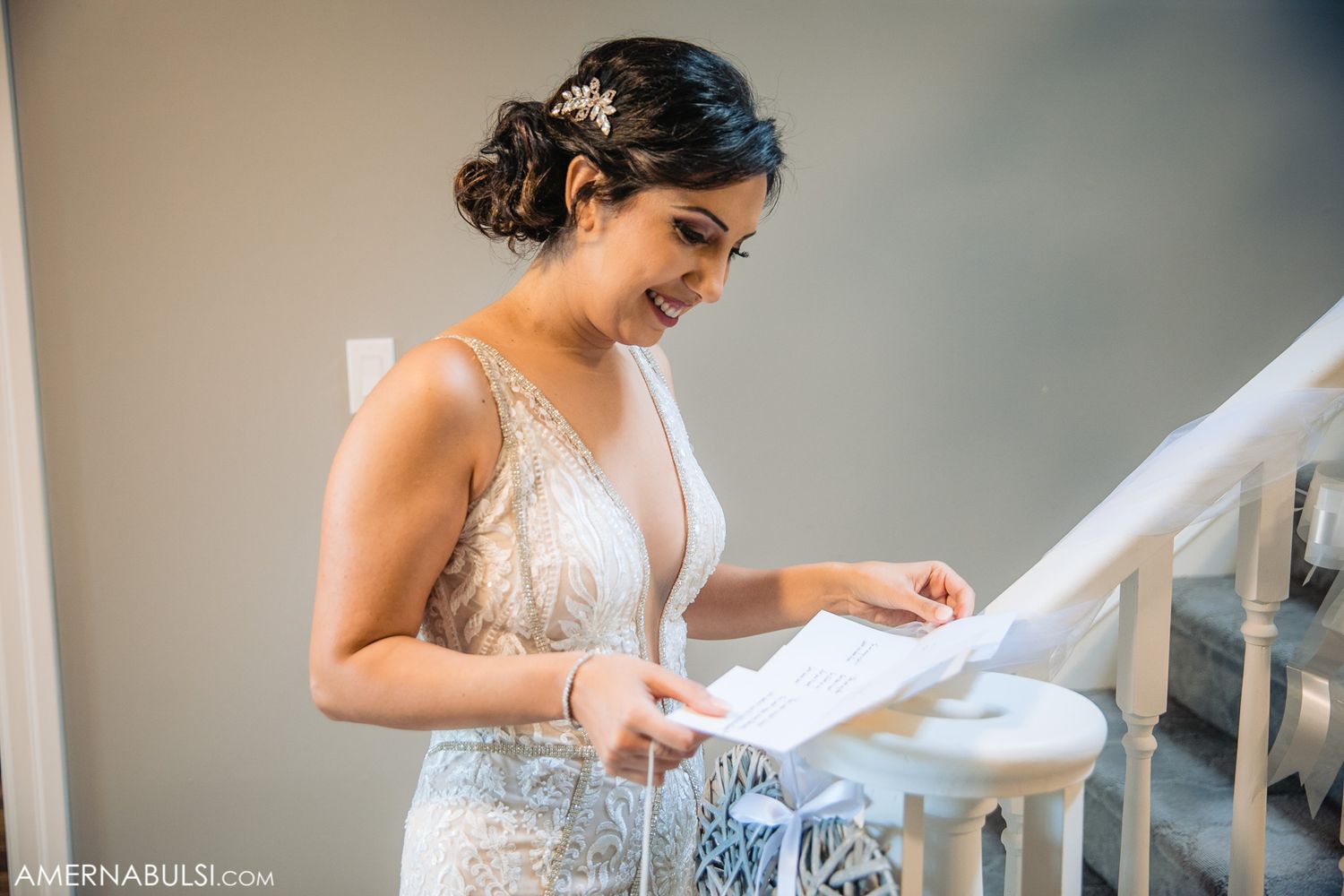 Getting ready moments captured in soft natural light on staircase.