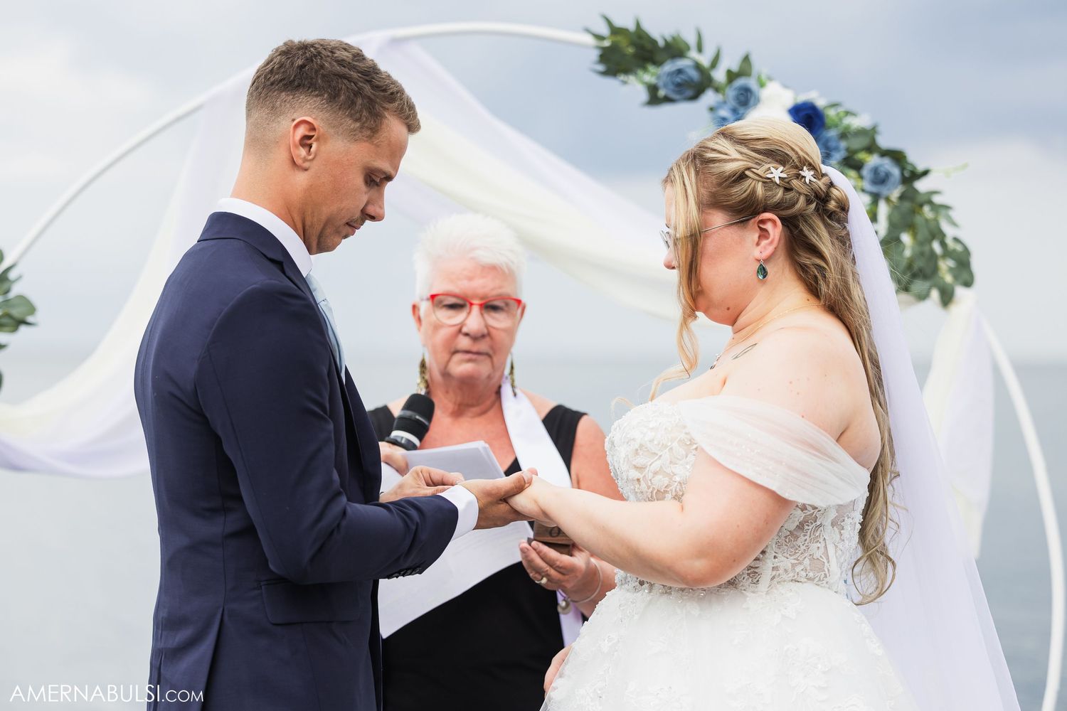 Wedding ceremony guests gather outdoors on a beautiful sunny day for an intimate celebration.
