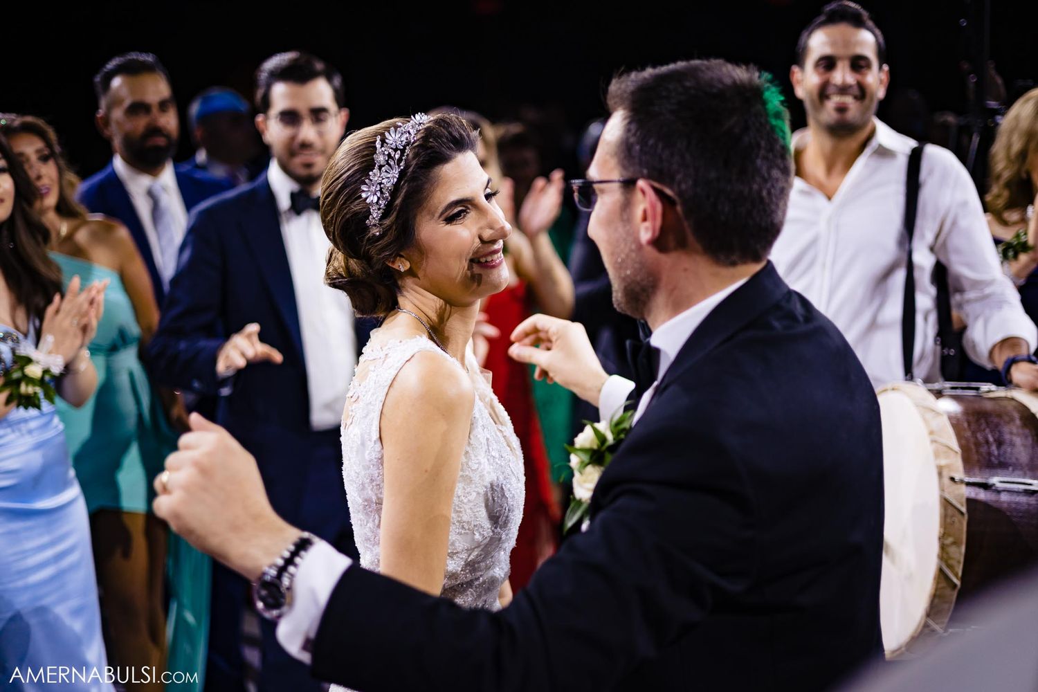 A couple shares an intimate moment during wedding reception celebrations.