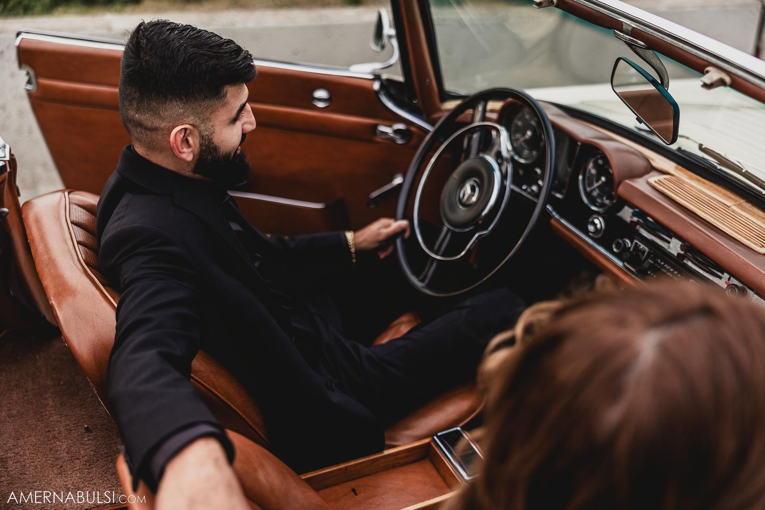 Classic Mercedes interior showing leather seats and vintage steering wheel.