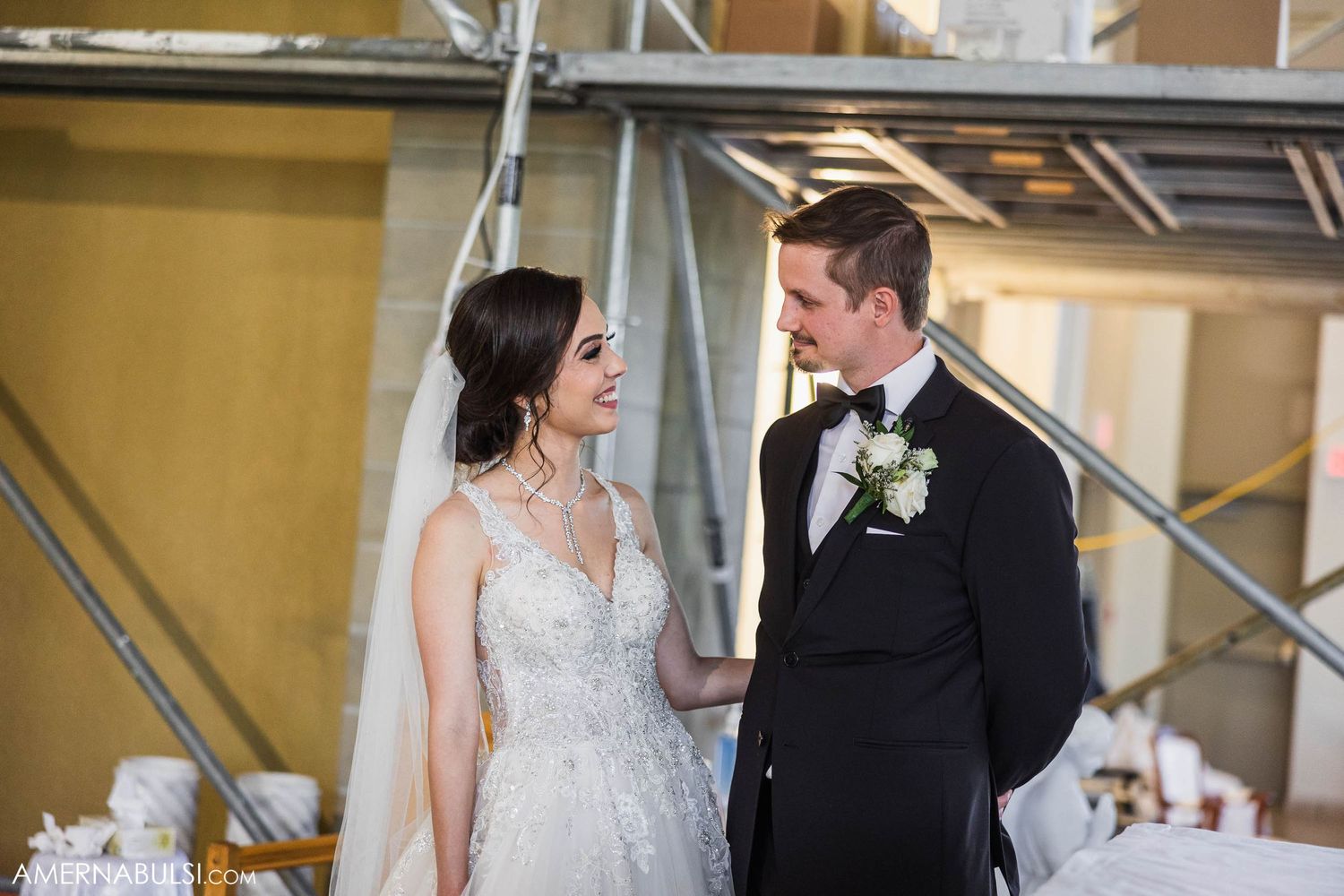 A romantic moment between newlyweds in formal attire at their church wedding.