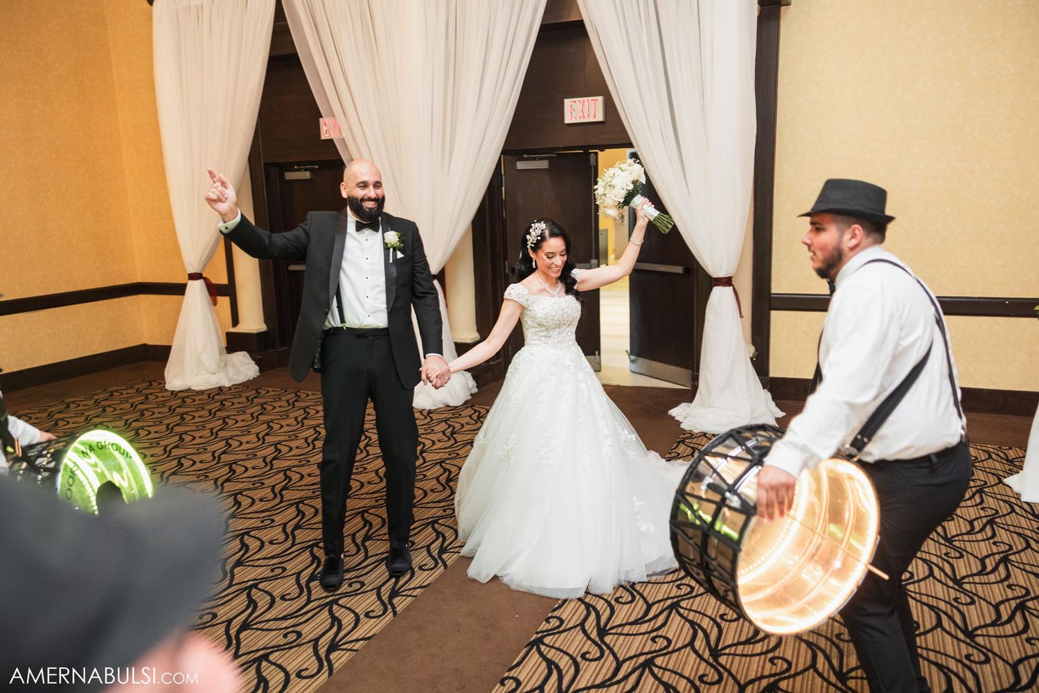 Wedding celebration with live band entertainment and dancing in an elegant ballroom.