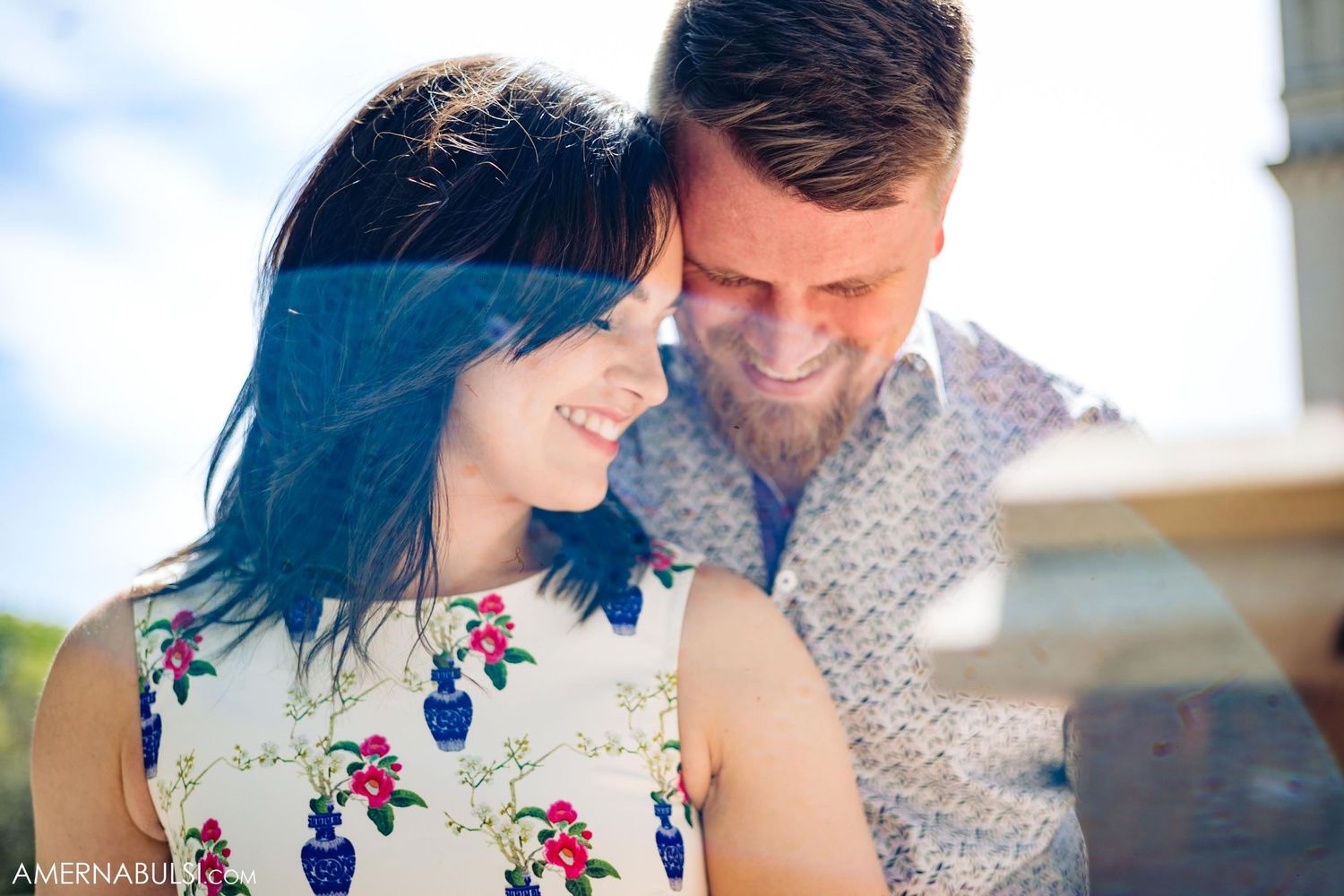 Couple in casual attire sharing a tender moment outdoors.