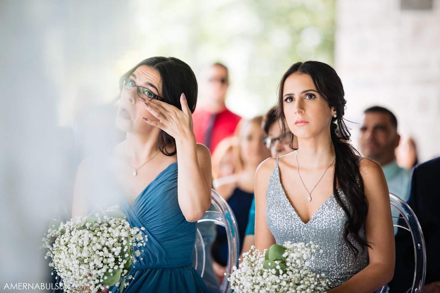Wedding party members in blue dresses and formal attire gathered for ceremony.