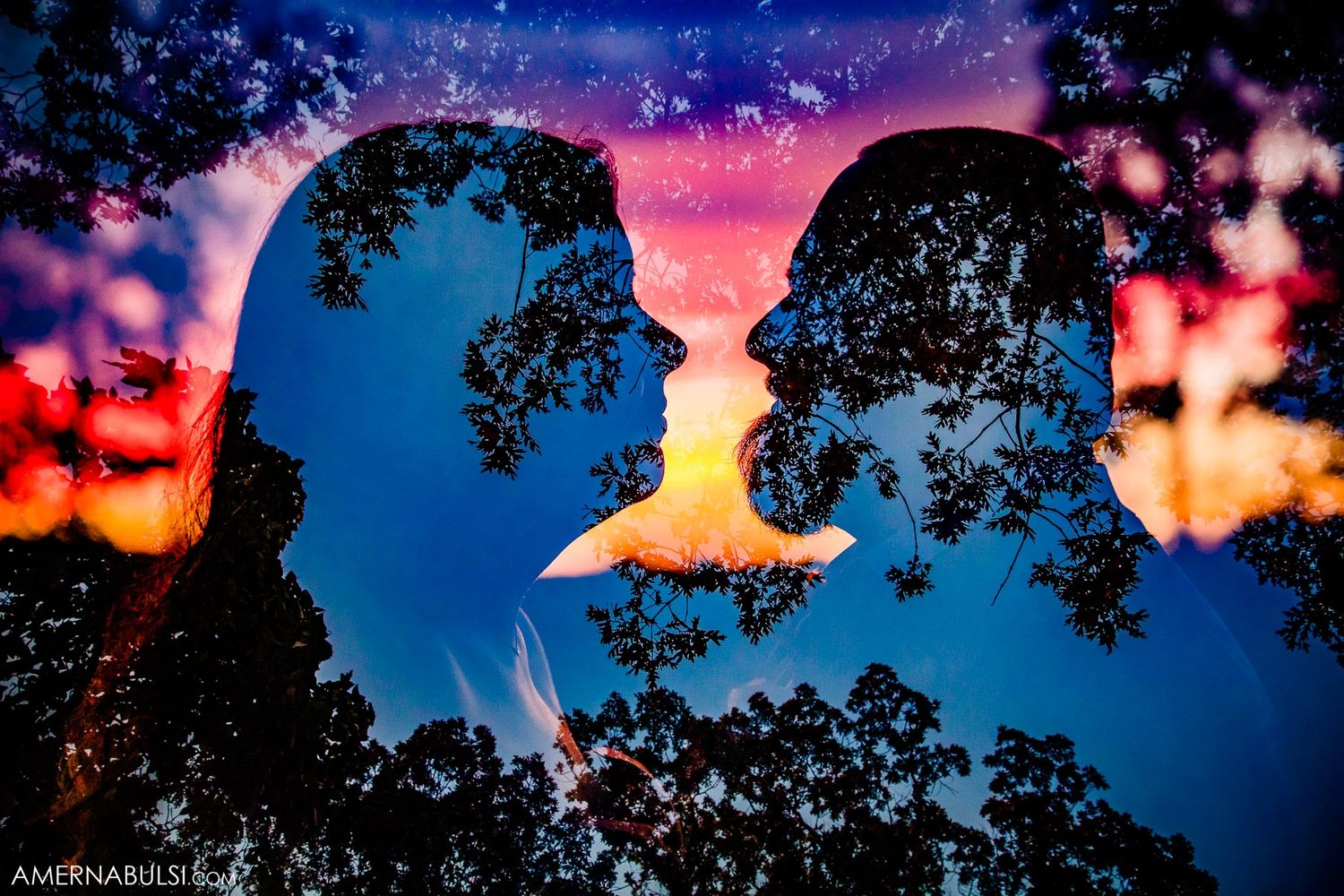 Dramatic sunset sky with silhouetted trees creating a romantic outdoor wedding backdrop.