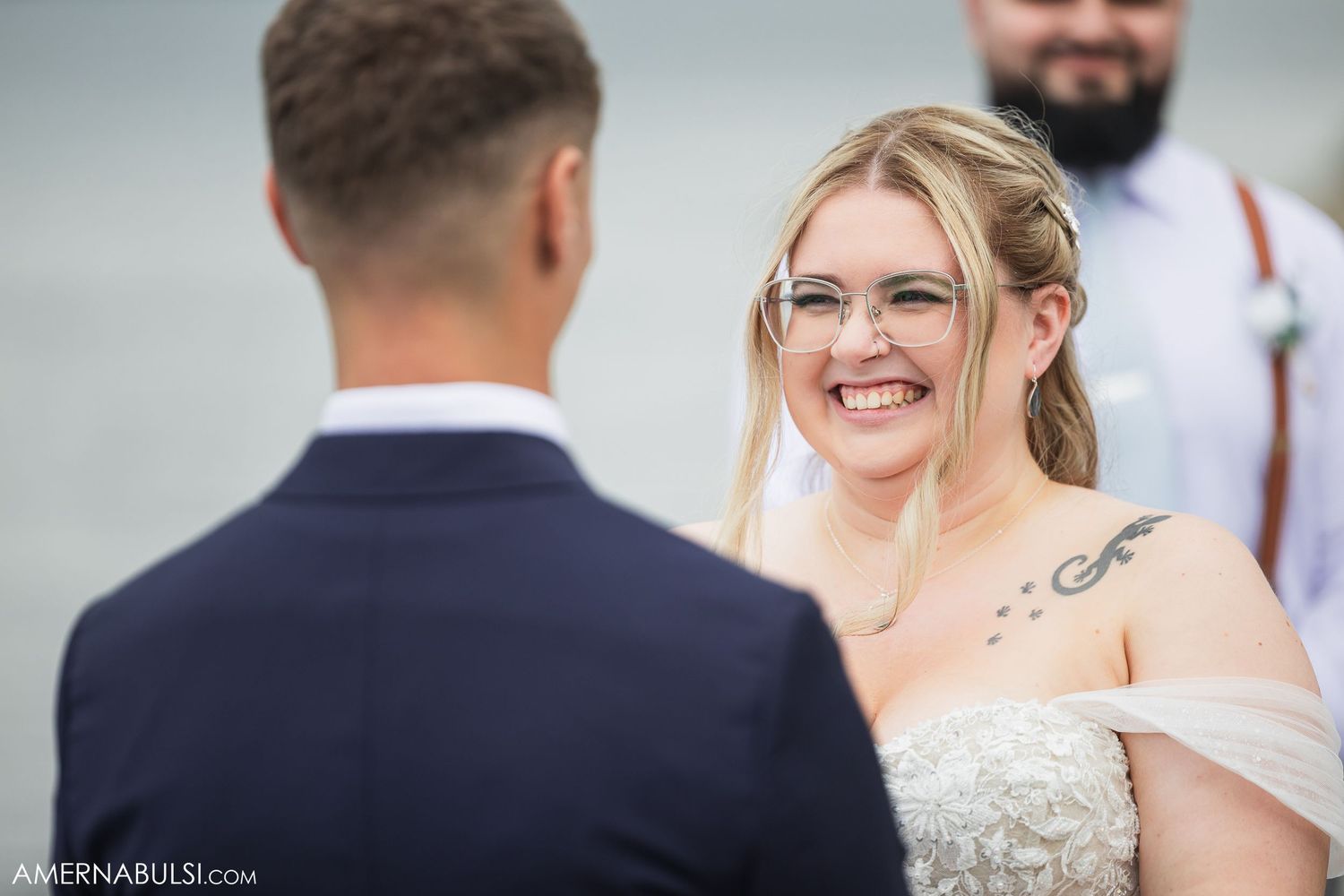 Close up of signing documents at an outdoor wedding ceremony.