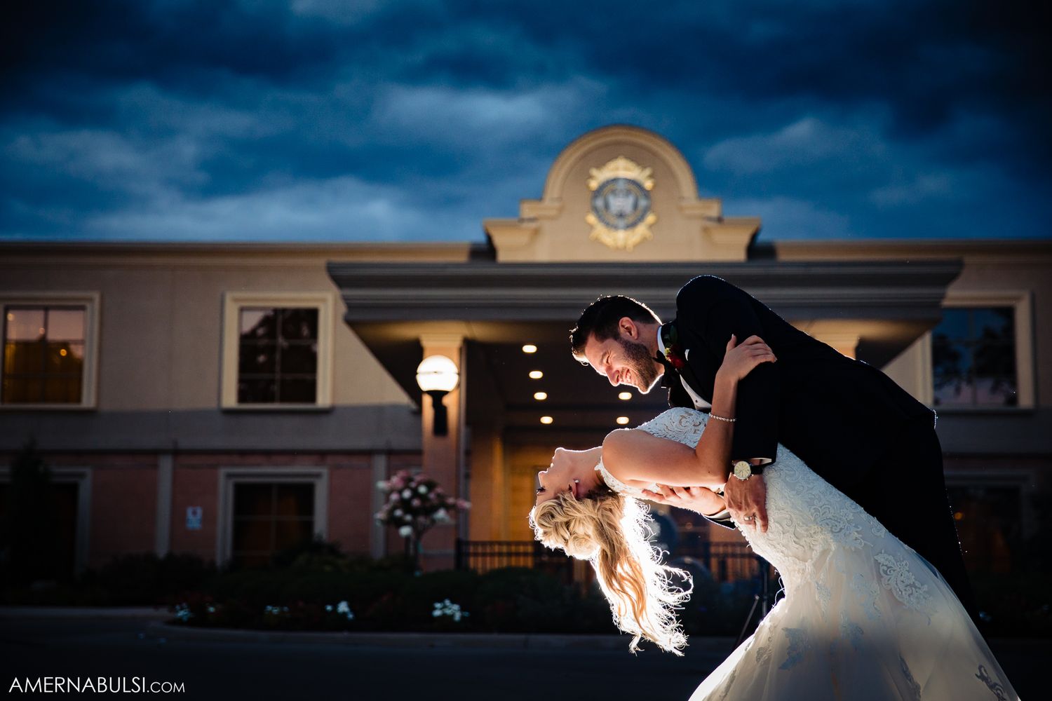 Romantic silhouetted couples dancing in an elegant ballroom with dramatic lighting and architectural details.
