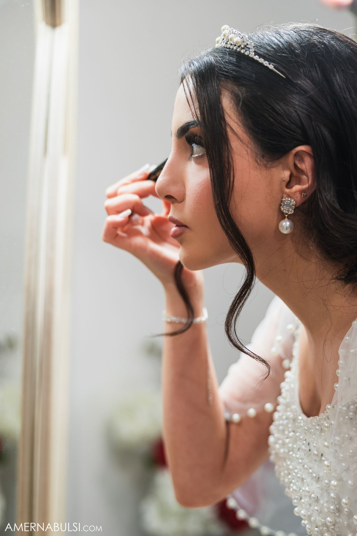 Close-up profile shots of a bride wearing sparkling jewelry and an elegant beaded wedding gown.