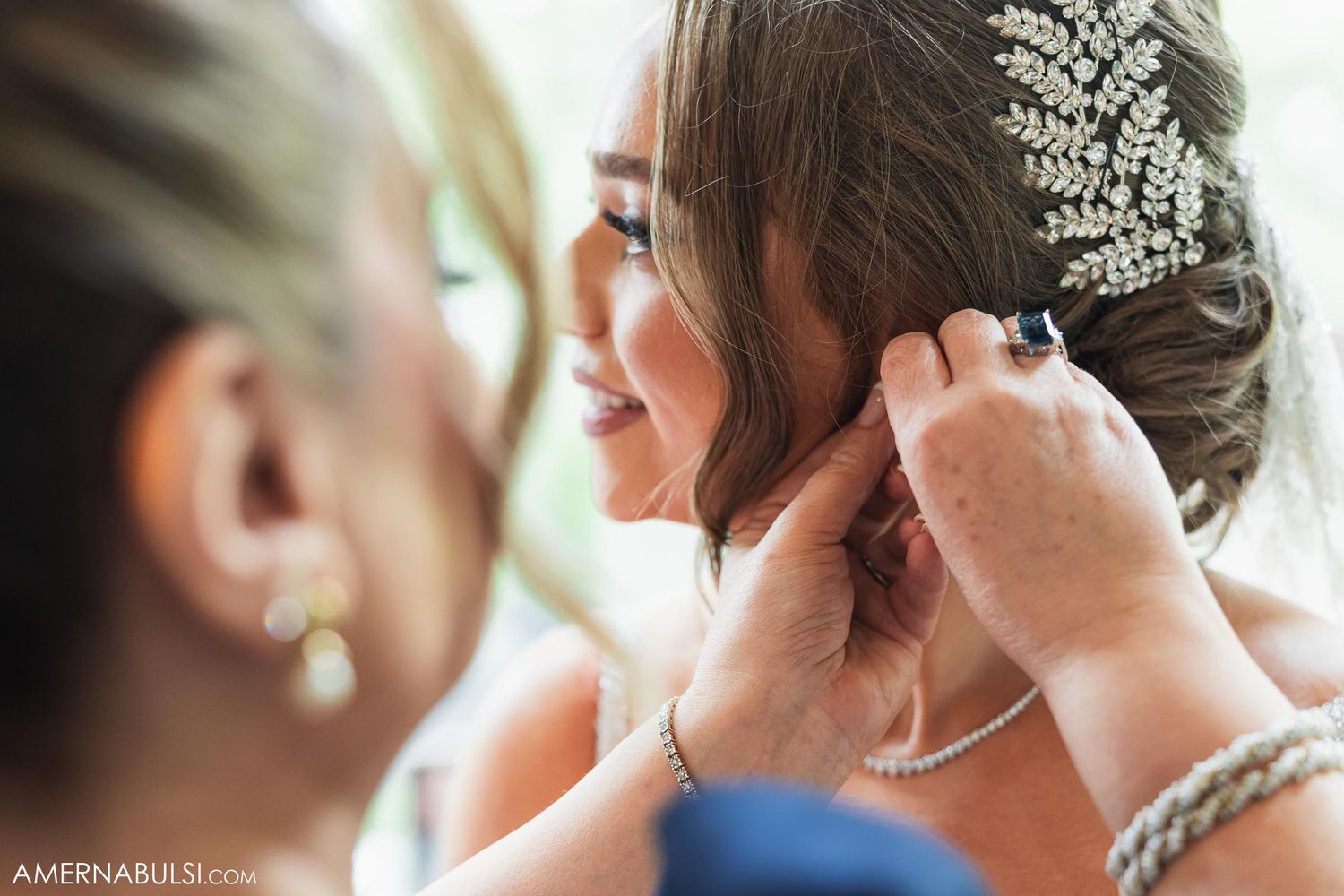 Close-up view of wedding day preparations showing delicate details and jewelry adjustments.