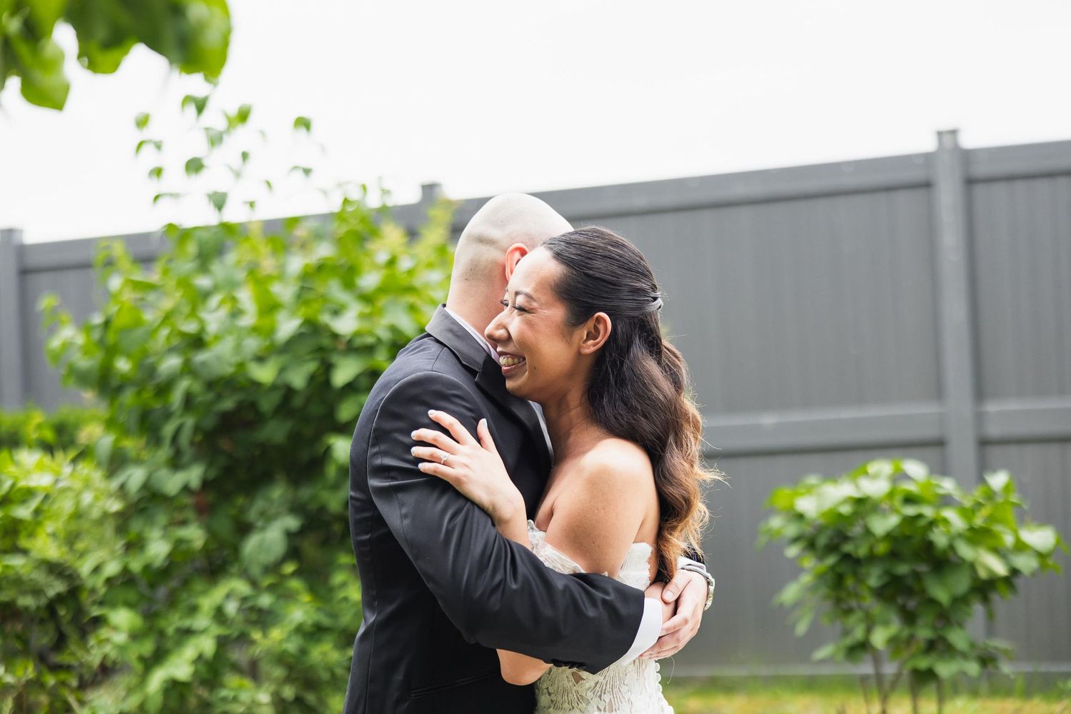 A couple sharing an intimate embrace during their outdoor wedding ceremony.