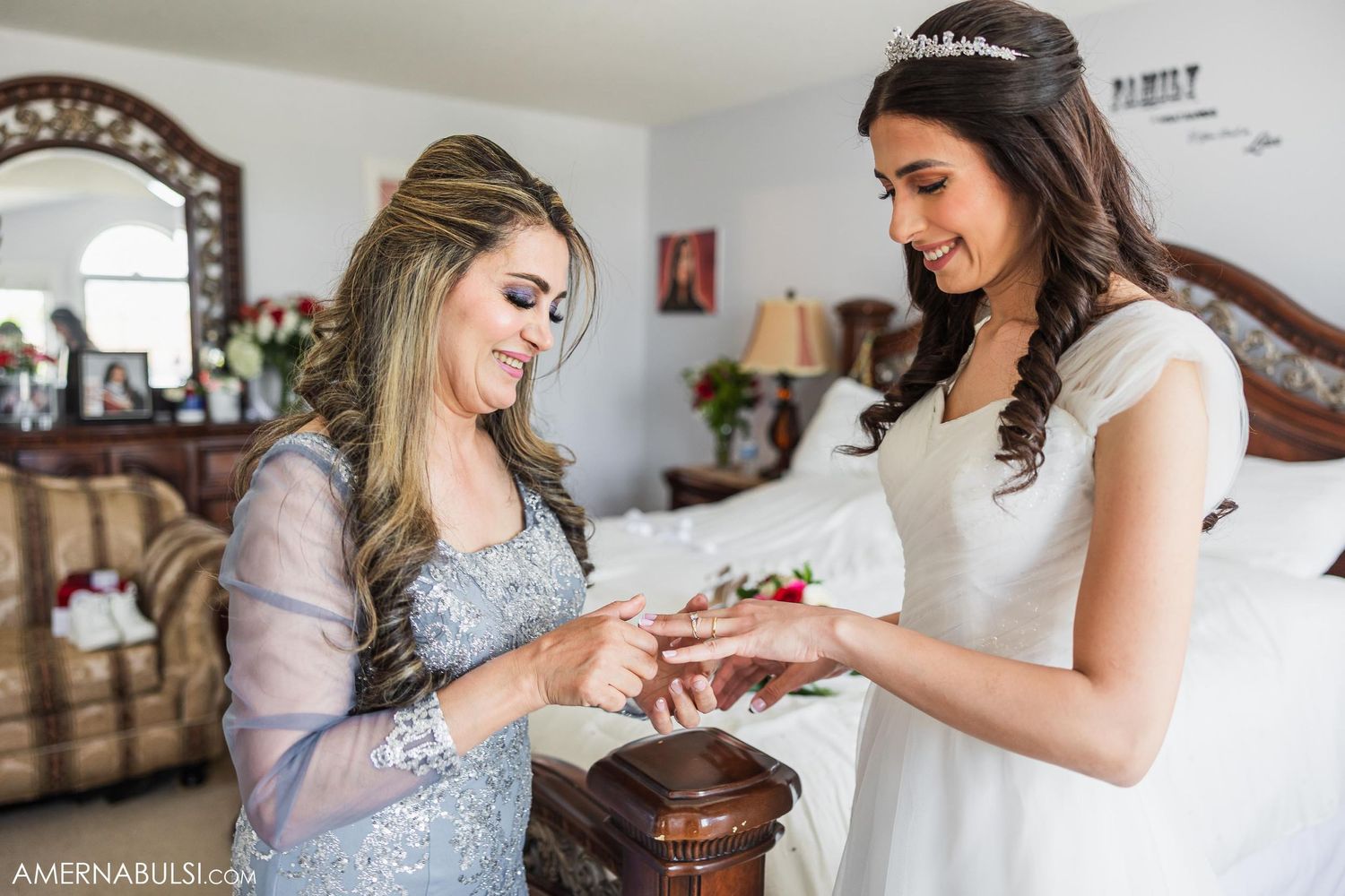 Two people exchange rings during an intimate wedding moment in a sunlit room.