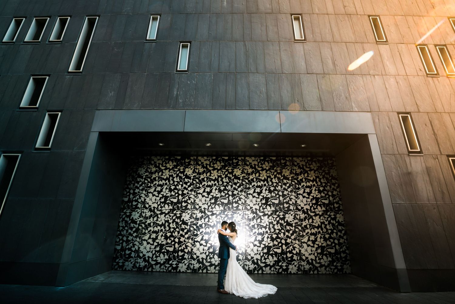 Modern architectural wedding photos with dramatic lighting and silhouettes.