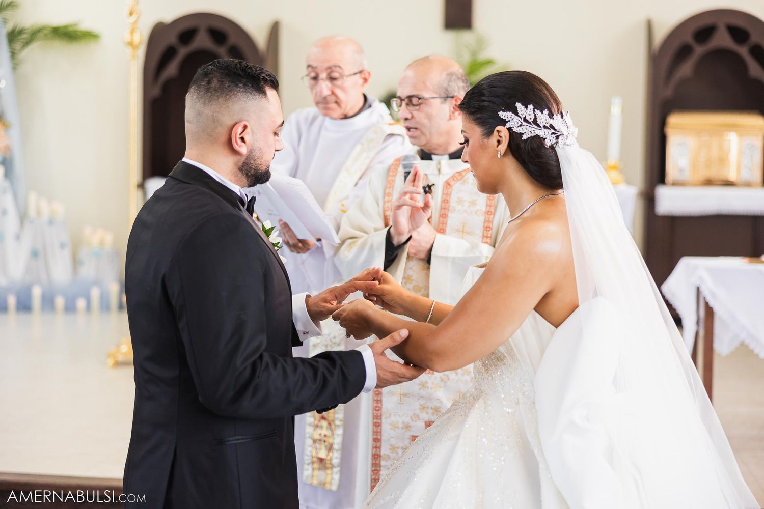 A wedding ceremony at the altar with priests officiating the marriage vows.