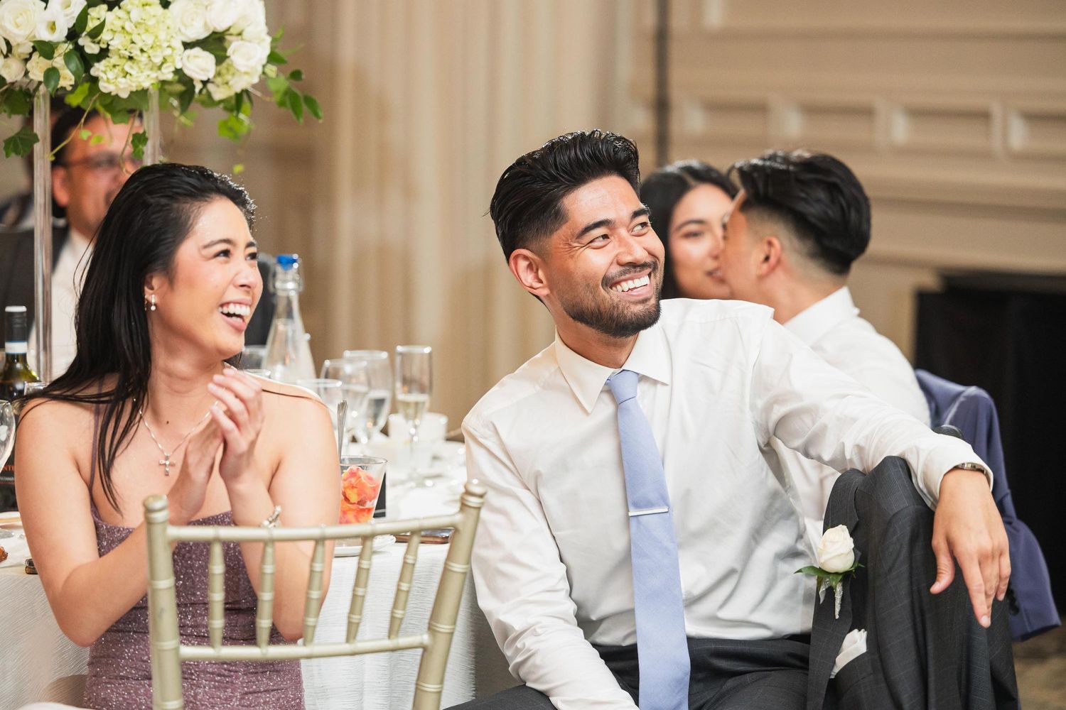 Wedding guests share laughter and joy during the reception dinner.