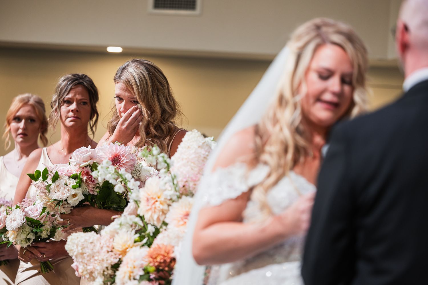 Wedding guests share joyful laughter and emotional moments during the reception celebration.