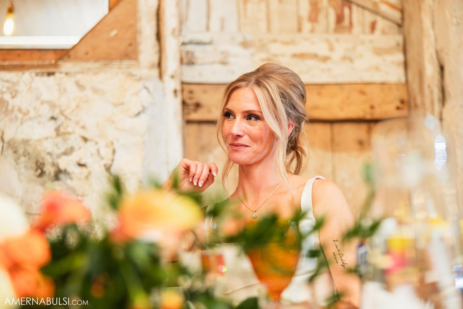 Elegant wedding reception setting with colorful floral arrangements and soft lighting.