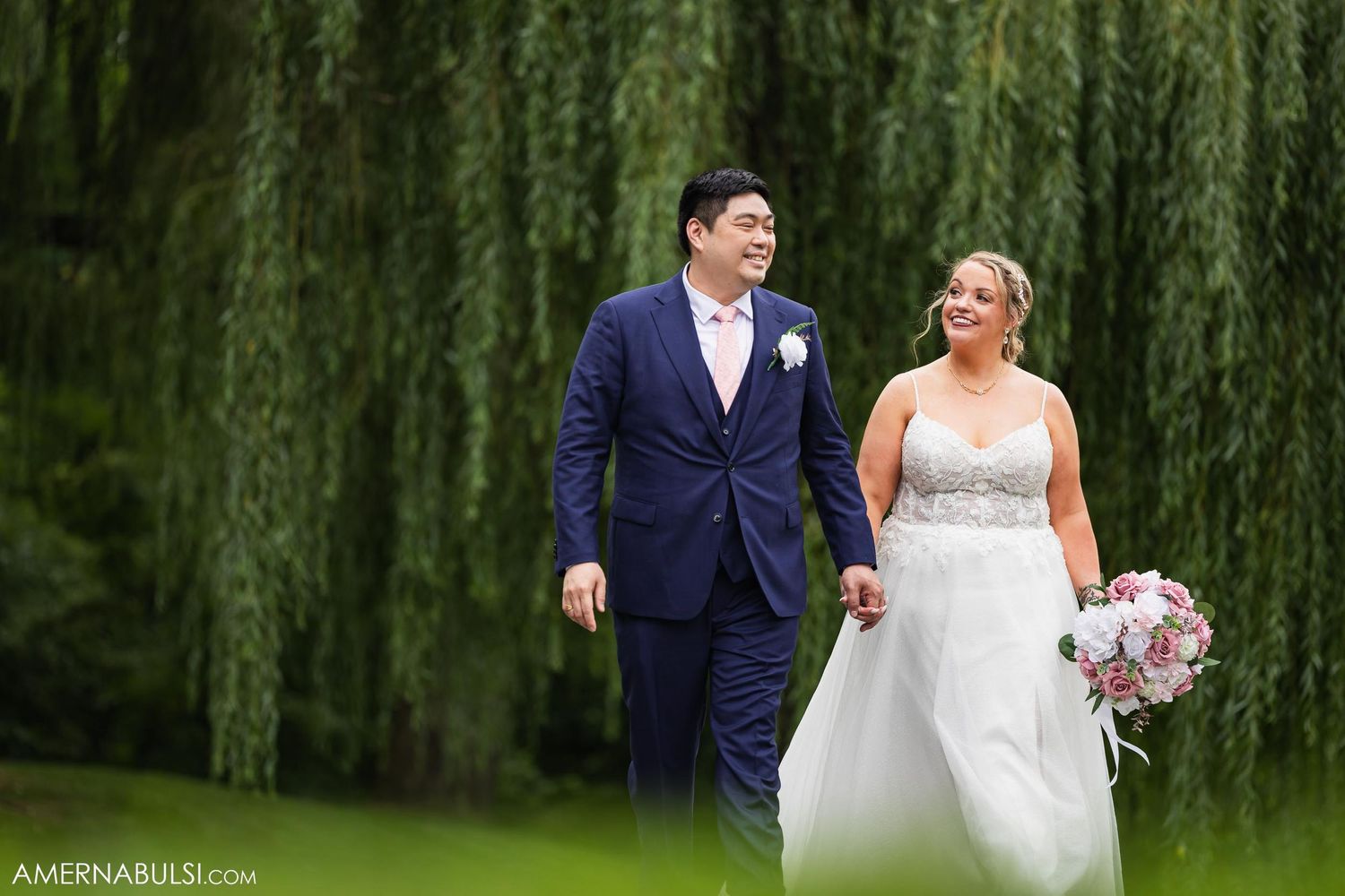 bride and groom walking through a golf course candid photo by Amer Nabulsi Photography