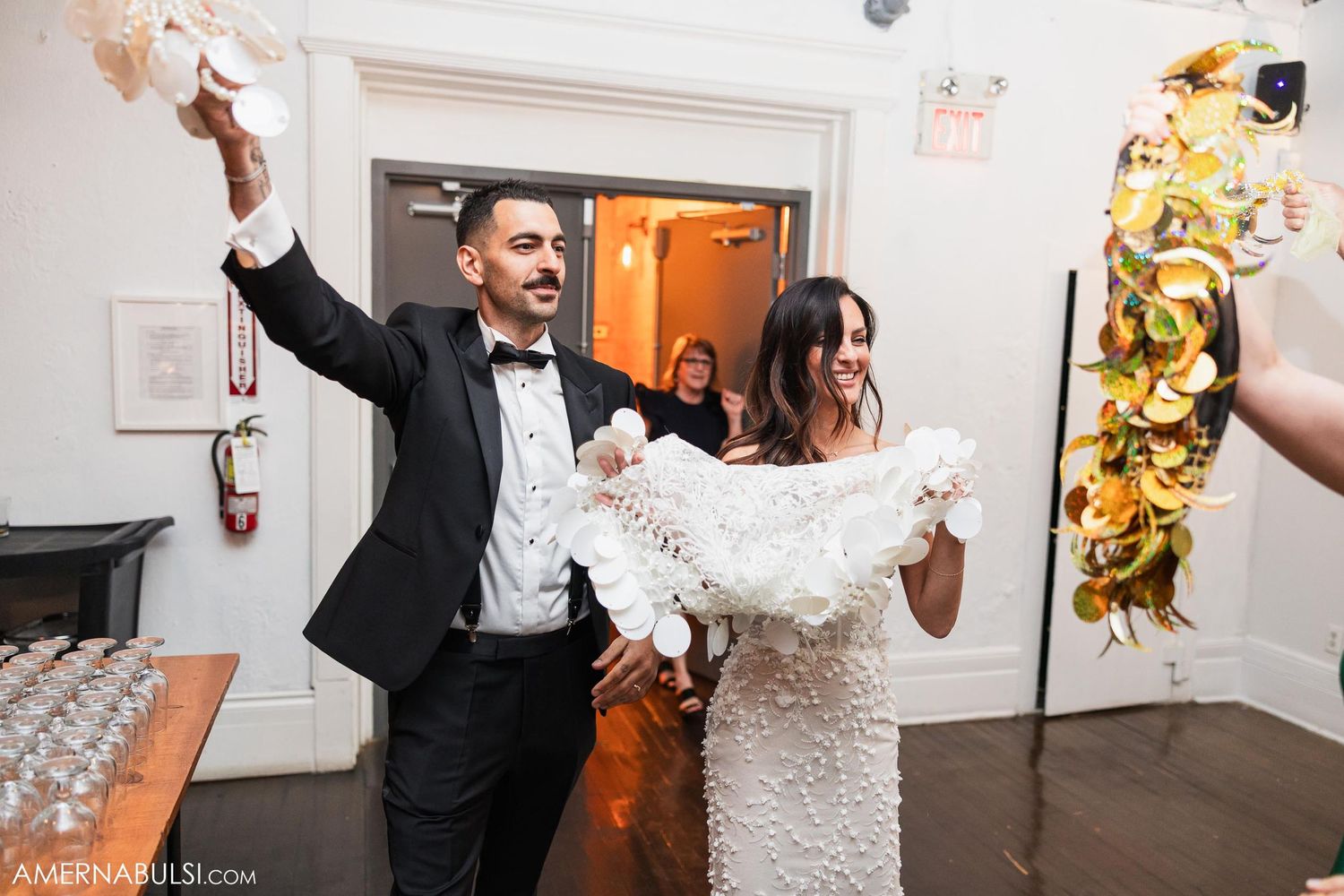 Couple celebrating with gold decorations at their wedding reception.