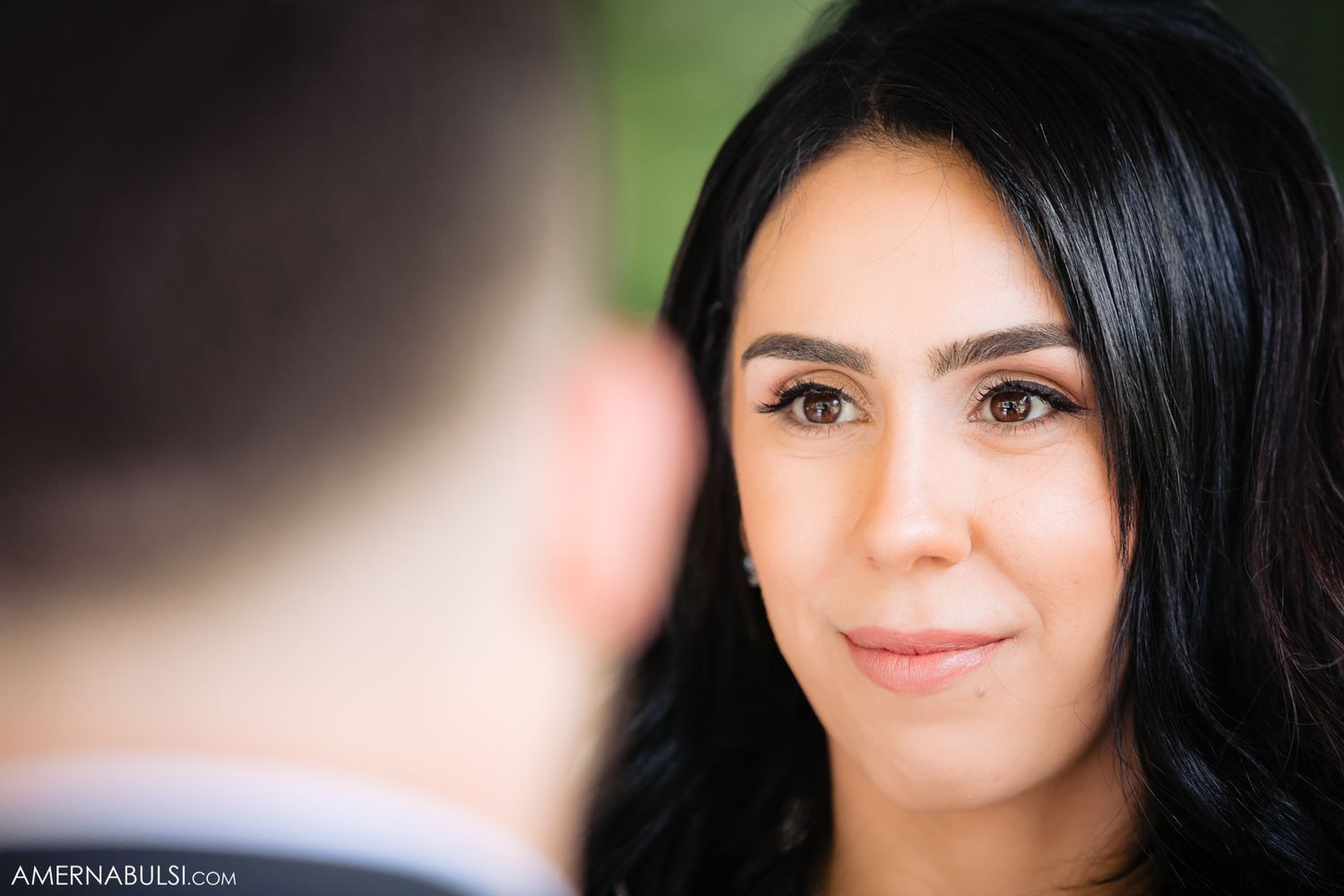 Close up portrait shot of a woman with dark hair and natural makeup on her wedding day.
