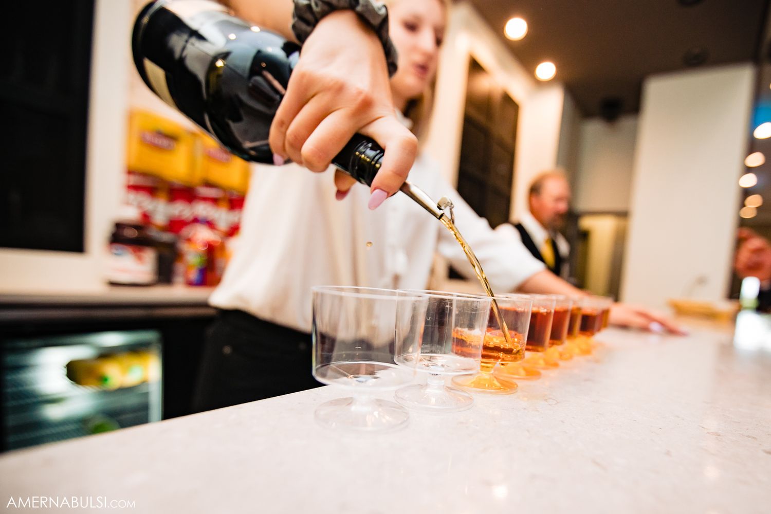 Close-up shots of hands preparing elegant food and drinks at an upscale event.
