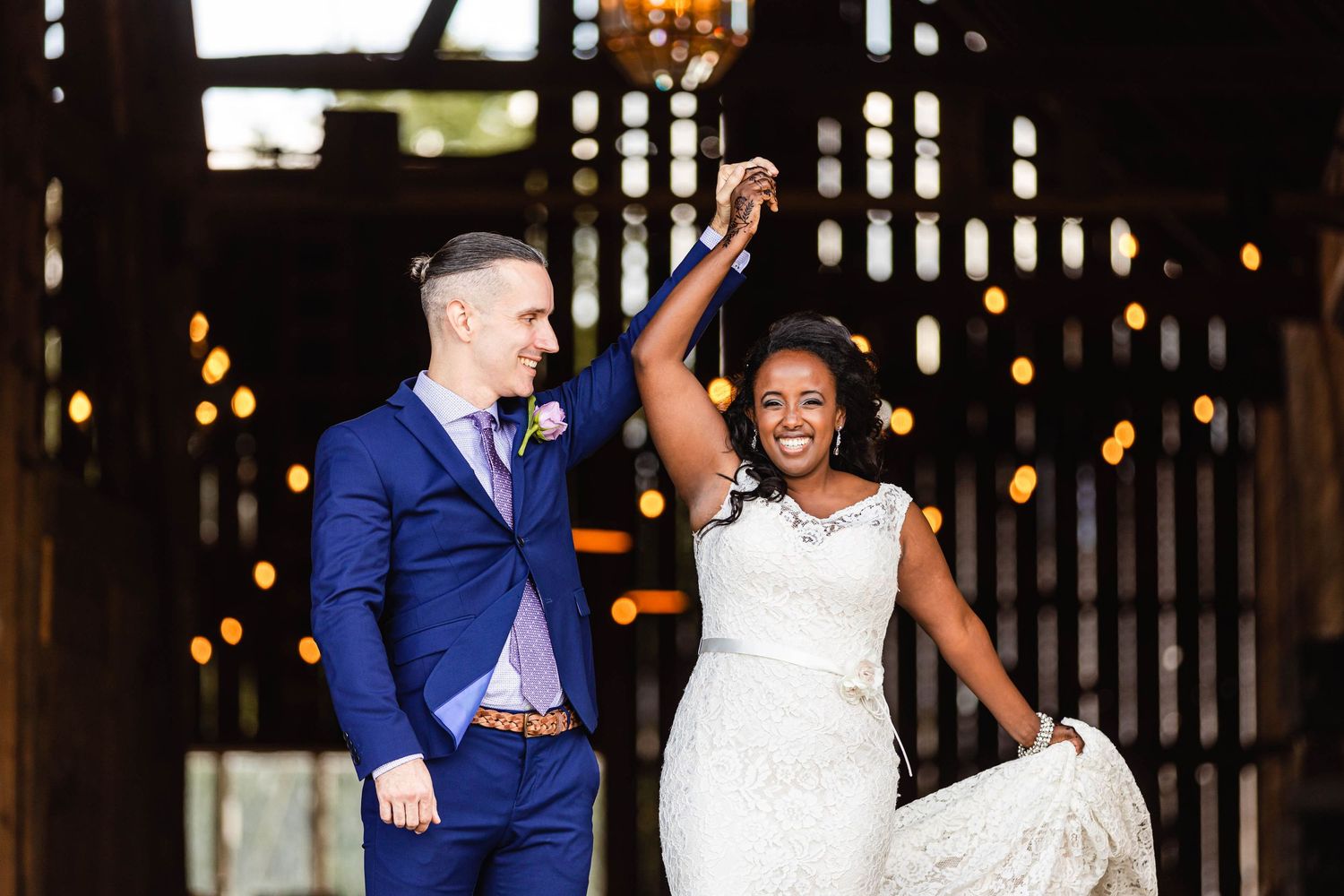 A joyful wedding celebration with a couple dancing outdoors in formal attire.