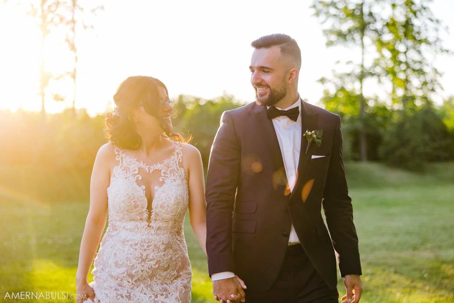 A happy couple laughs together during their sunset wedding photo session.