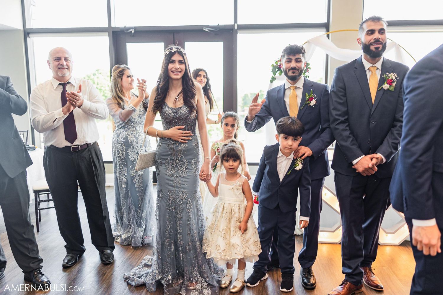 Wedding guests in formal attire celebrate during a reception event.