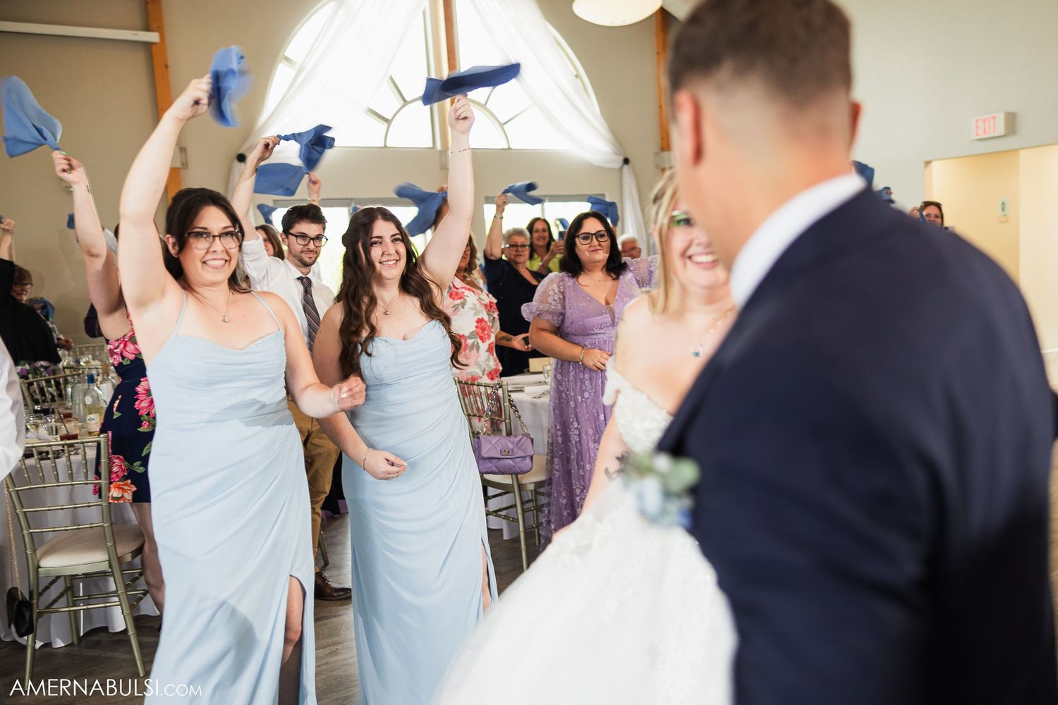 Wedding celebration with guests dancing and having fun at an elegant indoor reception.