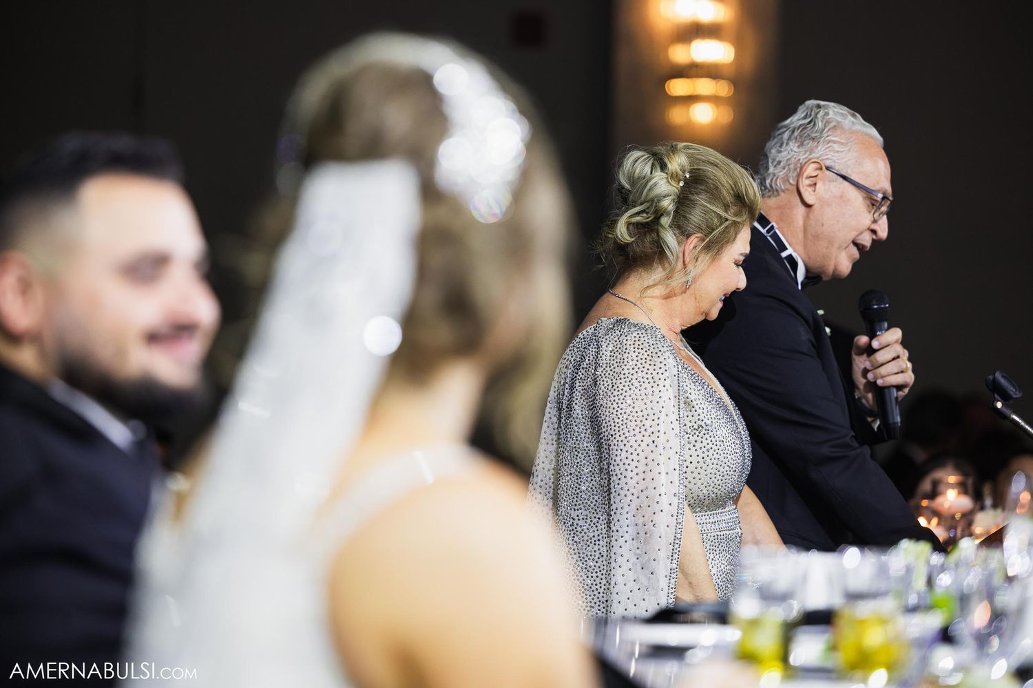 A candid speech moment during wedding reception celebrations.