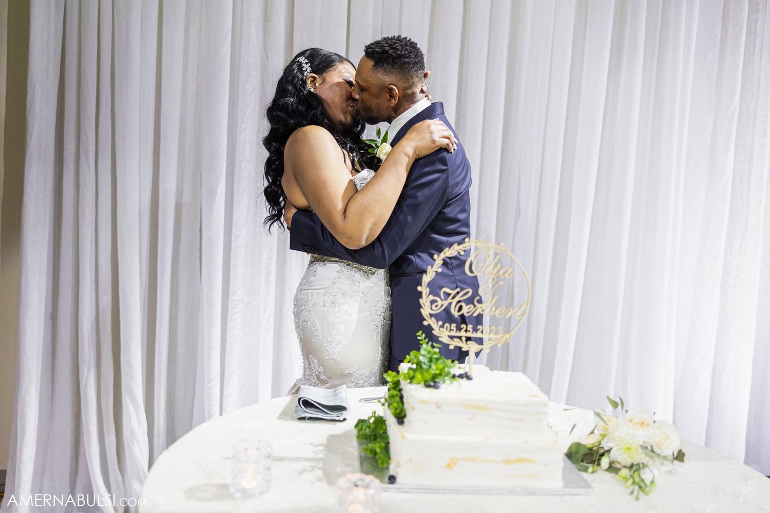 A groom dips his bride dramatically during a romantic dance at their wedding reception.