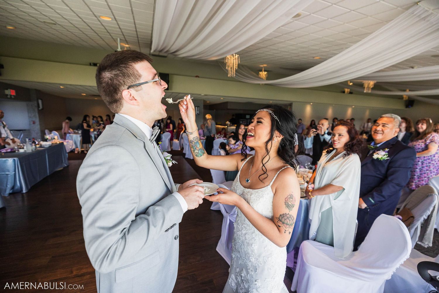 A candid moment of laughter and joy during wedding reception festivities.