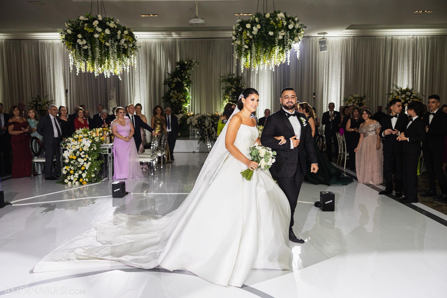 Bride and groom share romantic dance moment during wedding reception.