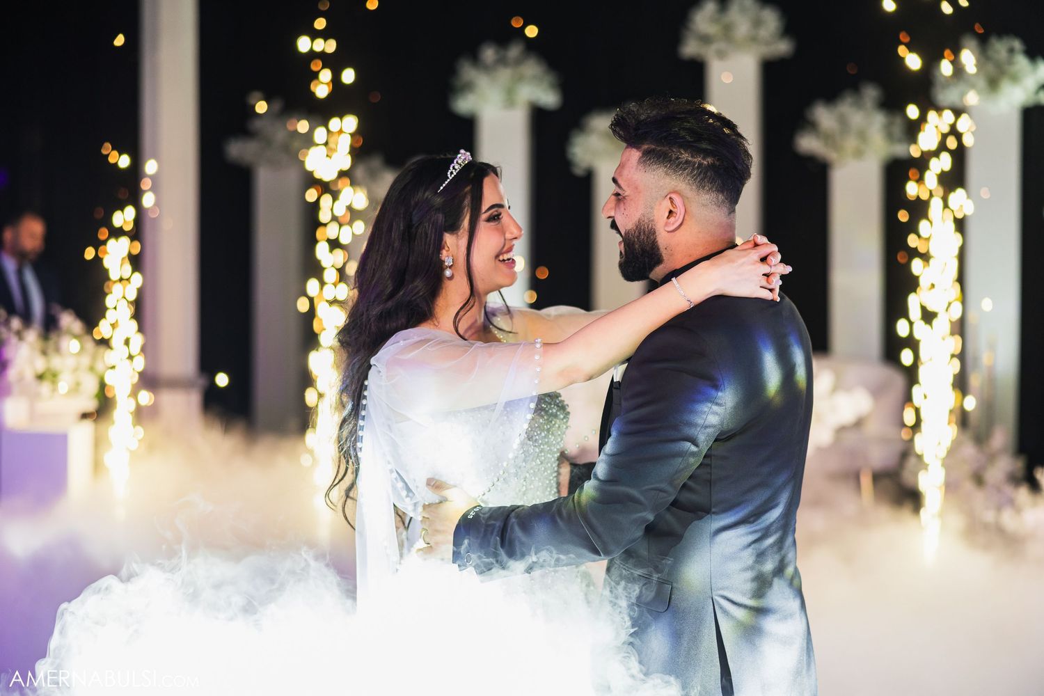 Wedding reception dance floor filled with joyful celebration and sparkling lights.