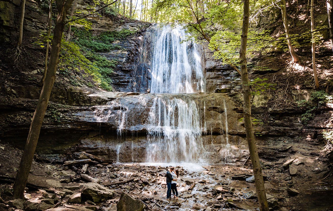 Series of scenic waterfall views in a lush forest setting.