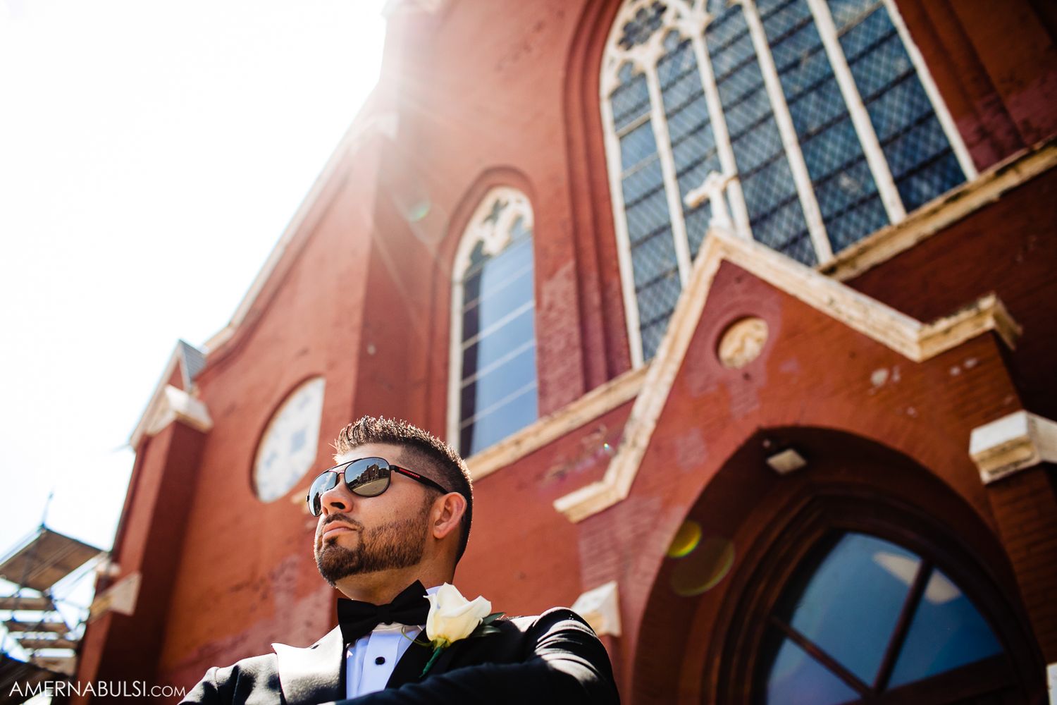 Red brick church exterior with arched windows photographed from a low angle.