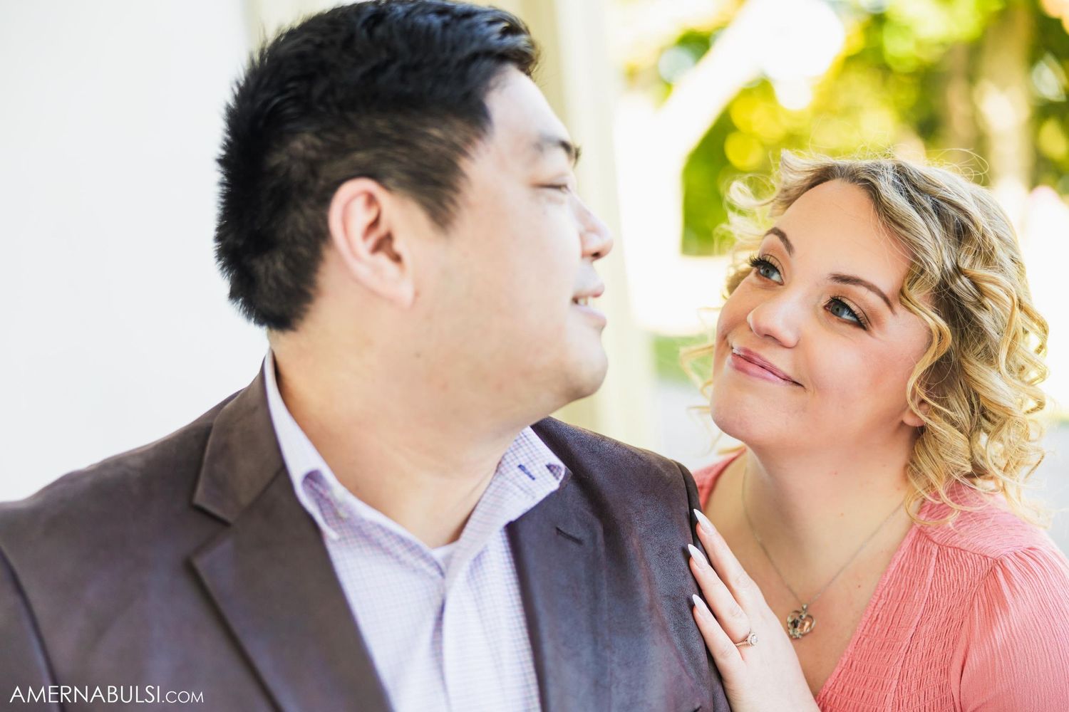 An engaged couple shares a tender moment during their outdoor photoshoot.