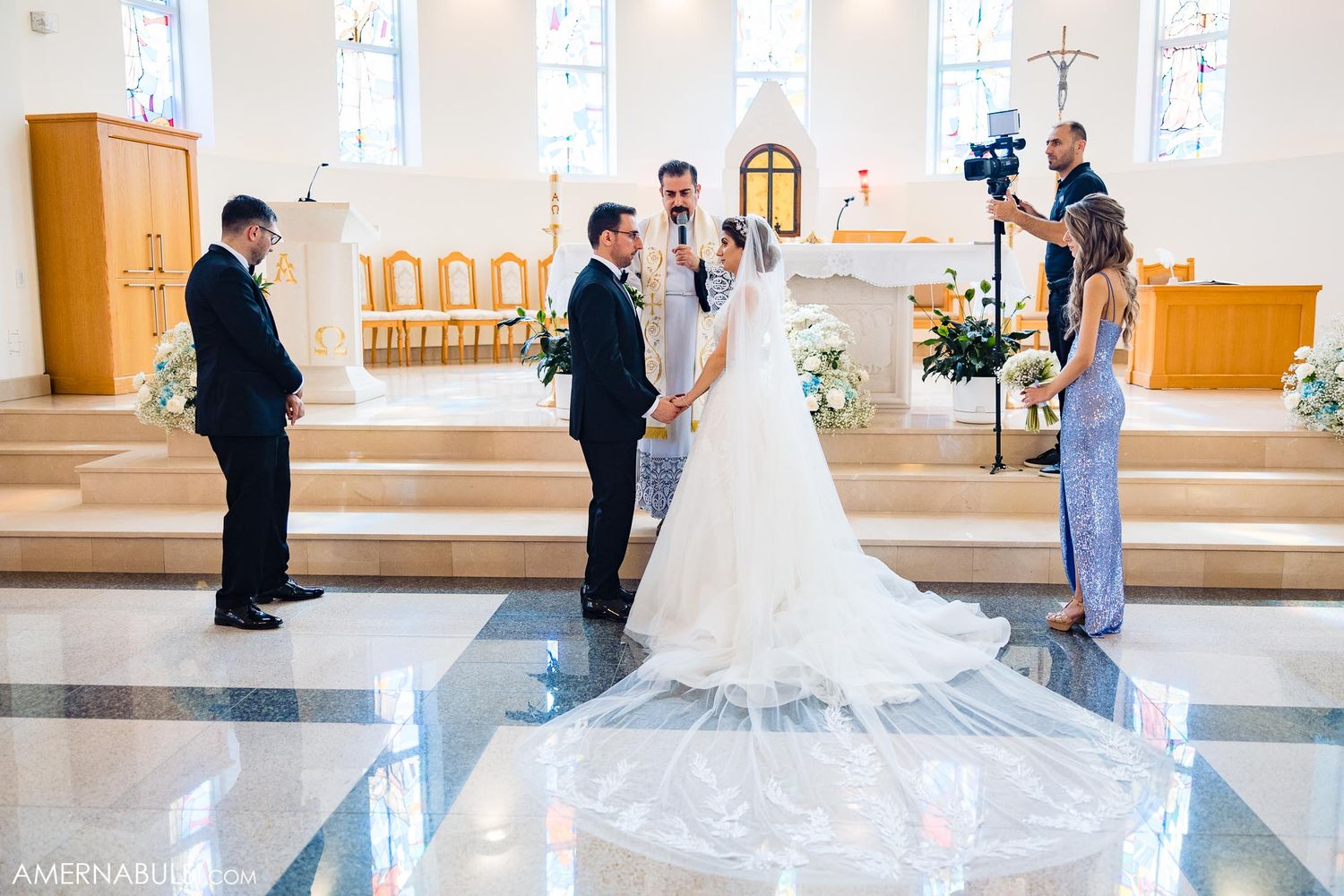 Behind the scenes view of wedding ceremony being photographed in church.