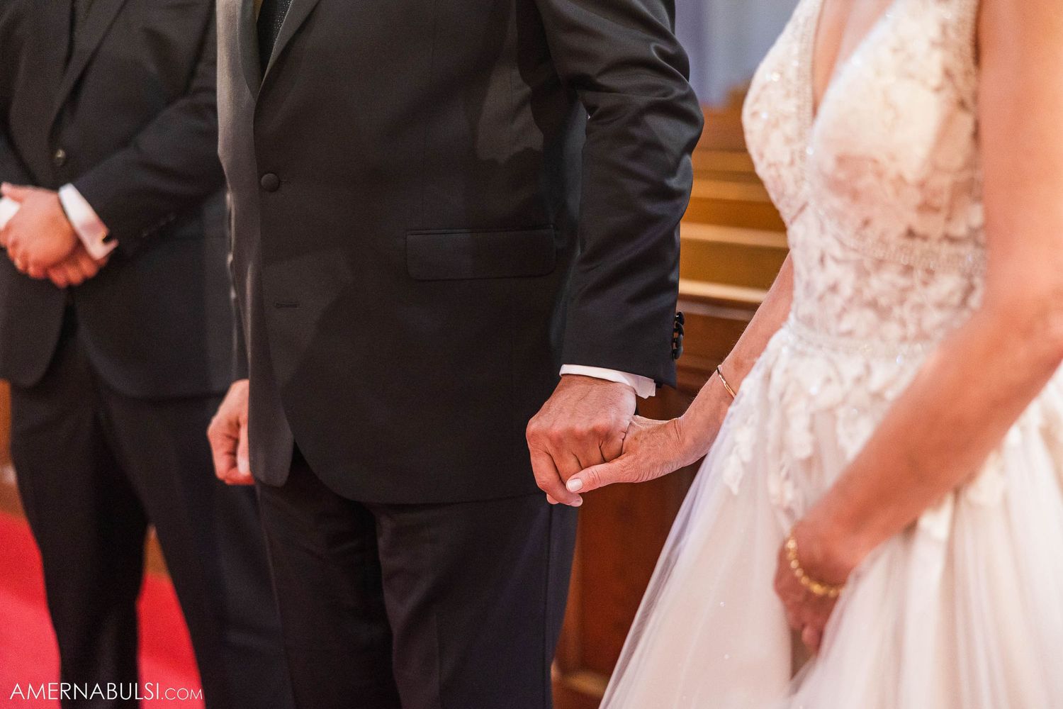 Close up of formal wedding attire during church ceremony.