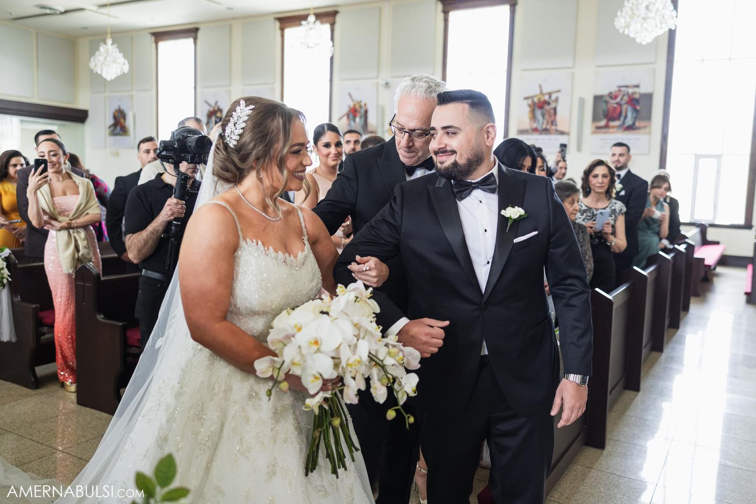 Wedding celebration in a church hall with elegant floral bouquet and formal attire.