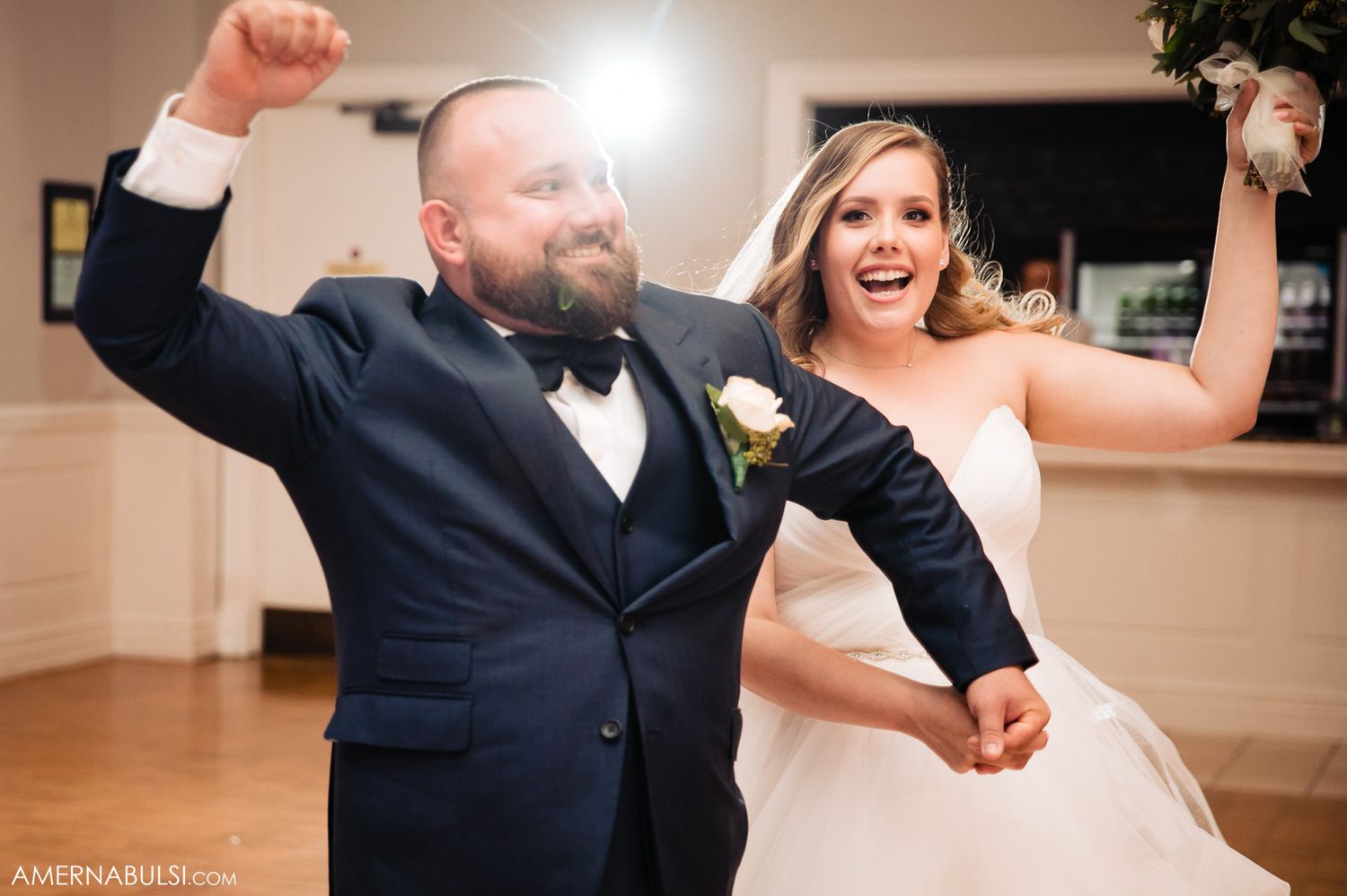 Joyful dancing and celebration captured during an elegant wedding reception.