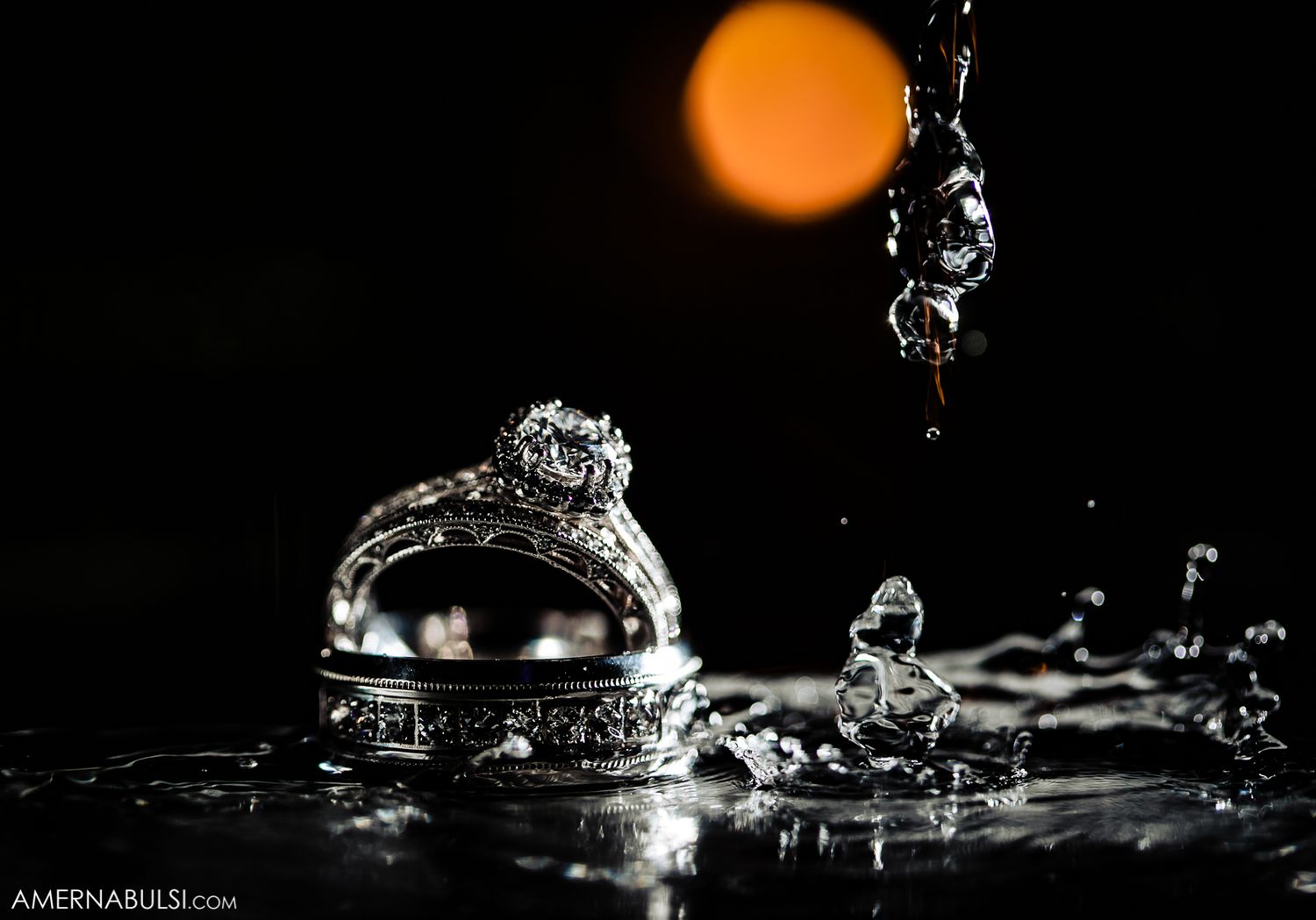 Orange water droplets splashing against dark background creating dramatic liquid art photography.