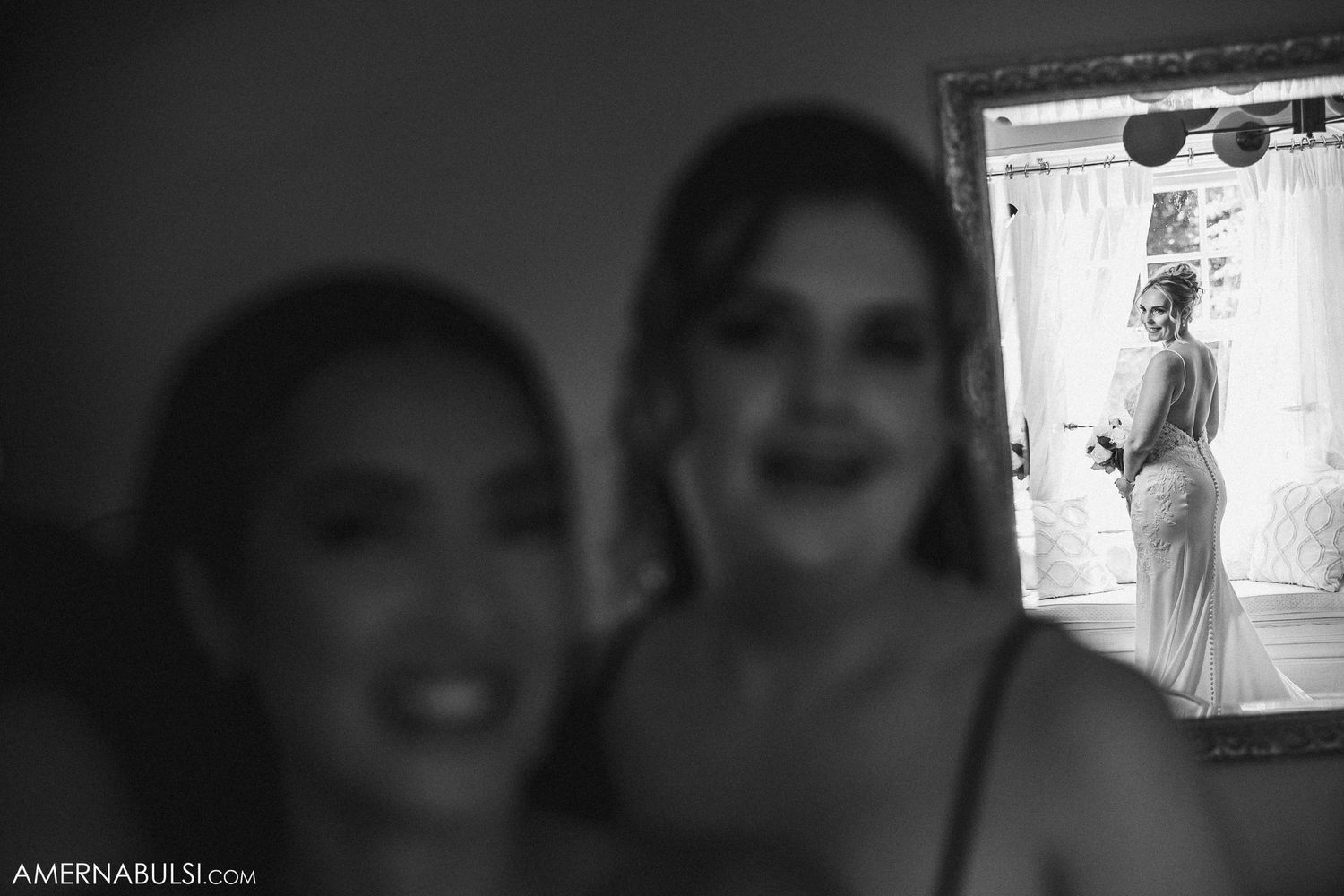 Black and white reflection of wedding preparations through mirror.