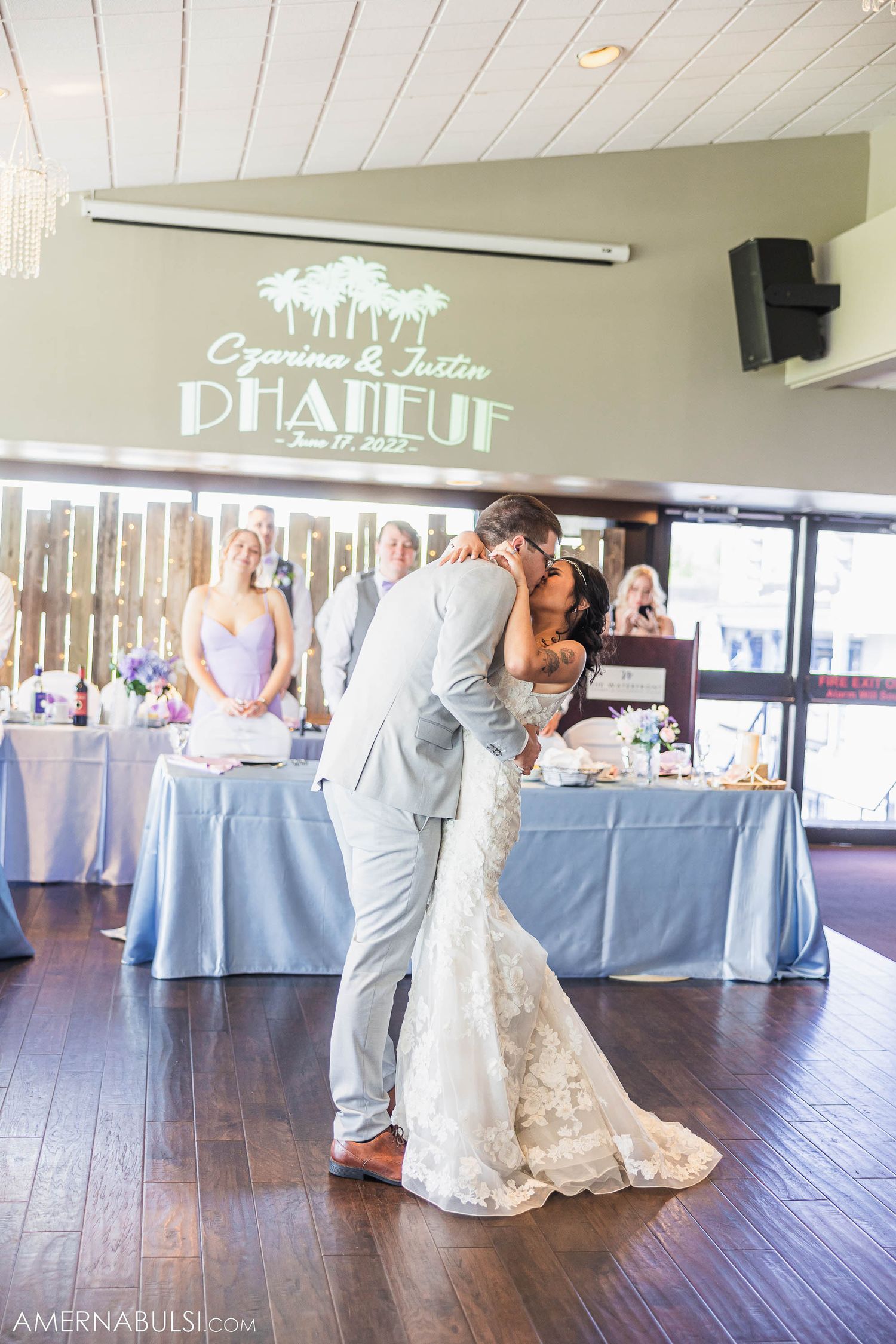 A romantic first dance moment under the Bhaleur venue sign at a wedding reception.